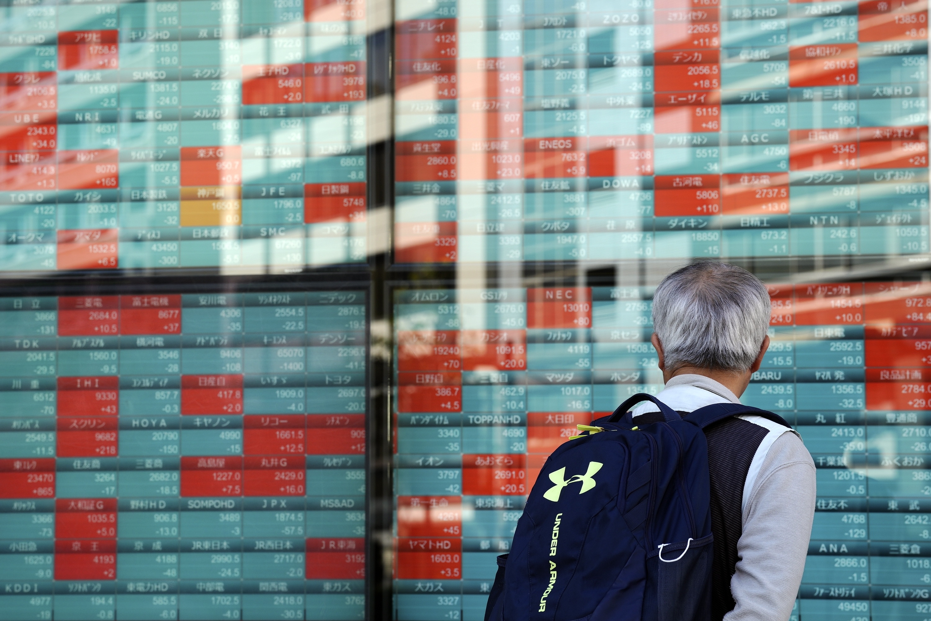 A person looks at an electronic stock board showing Japan's Nikkei index at a securities firm Wednesday, Nov. 13, 2024, in Tokyo. (AP Photo/Eugene Hoshiko)