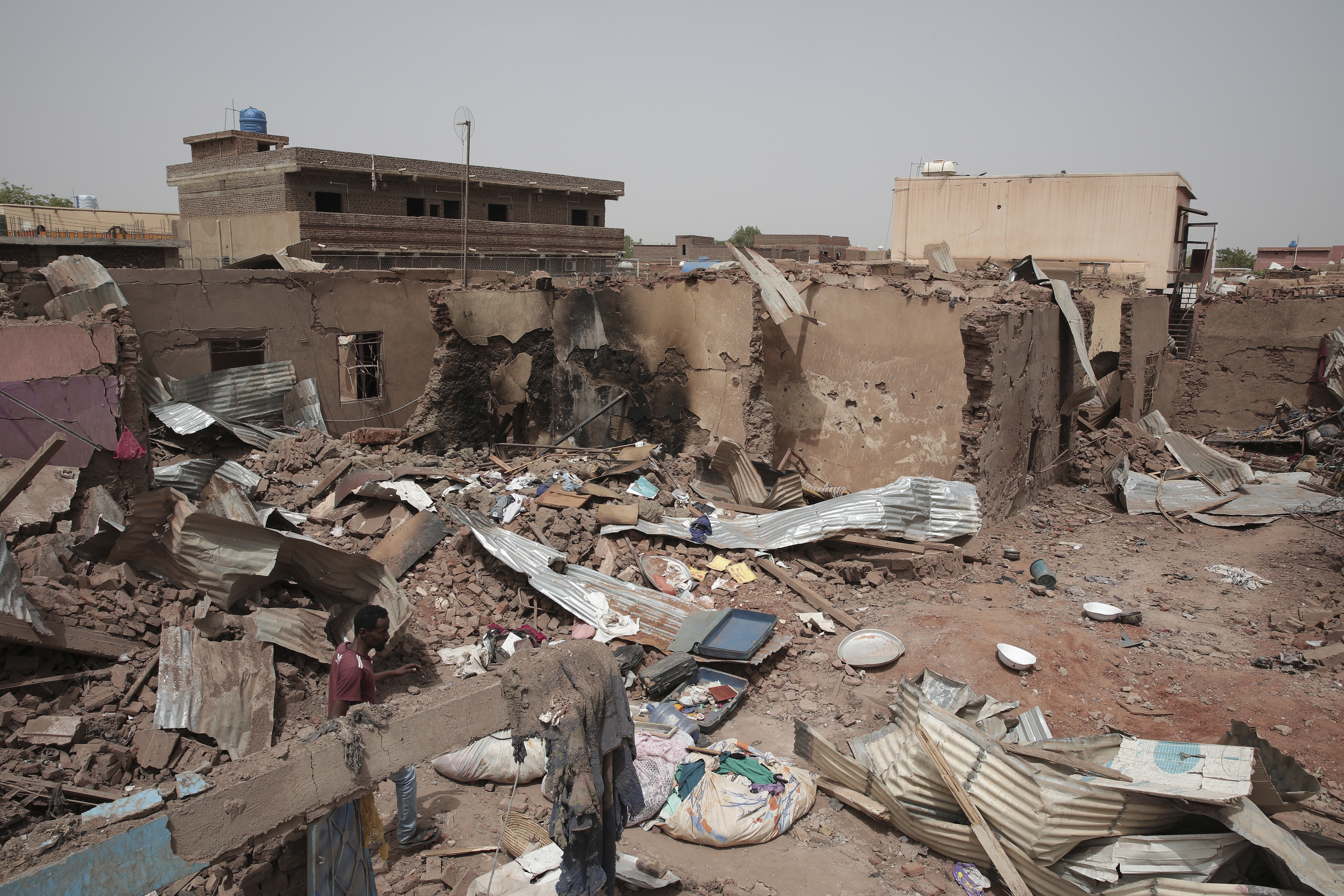 File - A man walks by a house hit in recent fighting in Khartoum, Sudan, an area torn by fighting between the military and the notorious paramilitary Rapid Support Forces, April 25, 2023. (AP Photo/Marwan Ali, File)