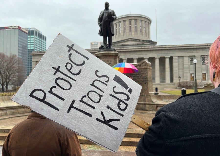 FILE - Protesters advocating for transgender rights and healthcare stand outside of the Ohio Statehouse, Jan. 24, 2024, in Columbus, Ohio. (AP Photo/Patrick Orsagost, File)