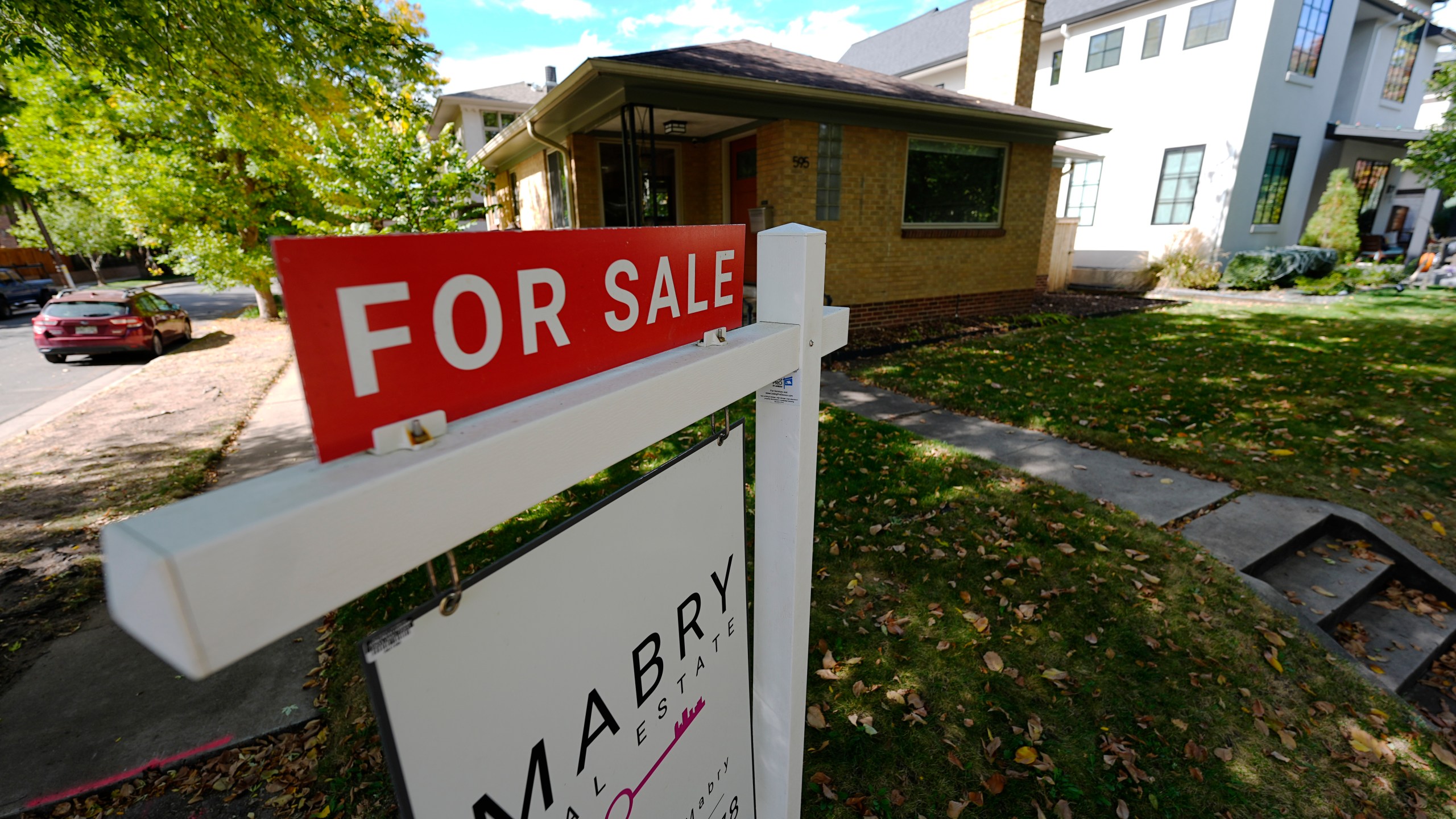 FILE - A sale sign stands outside a home on the market Thursday, Oct. 17, 2024, in the east Washington Park neighborhood of Denver. (AP Photo/David Zalubowski, File)