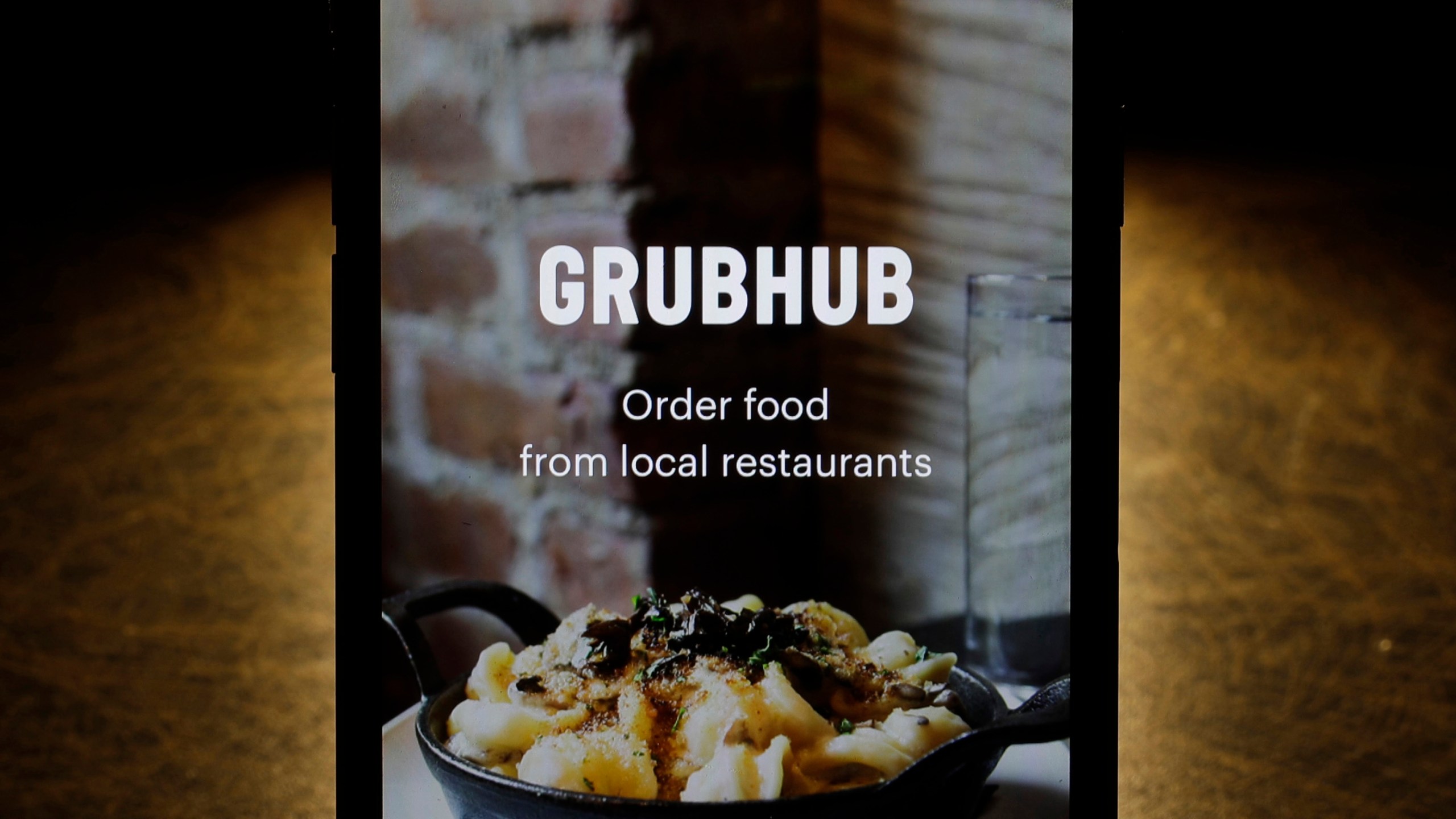 FILE - The Grubhub app is seen on an iPhone in Chicago, Feb. 20, 2018. (AP Photo/Charles Rex Arbogast, File)