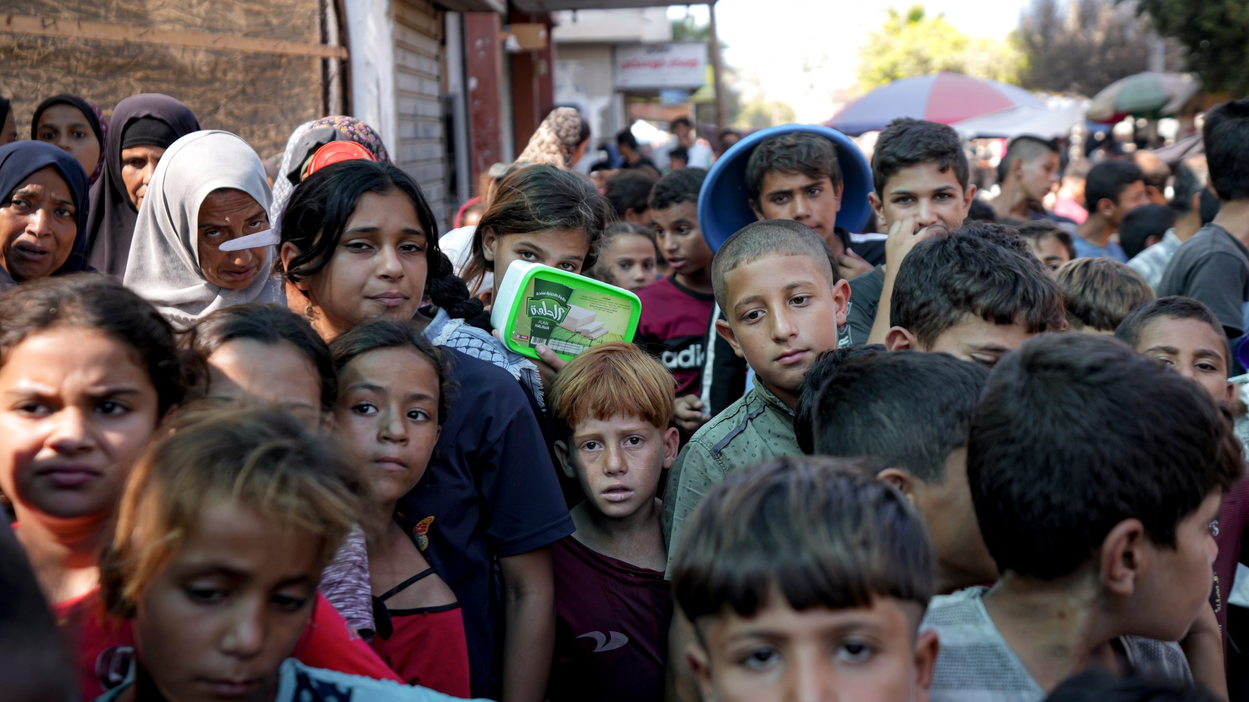 FILE - Palestinians line up for food distribution in Deir al-Balah, Gaza Strip, on Oct. 17, 2024. (AP Photo/Abdel Kareem Hana, File)