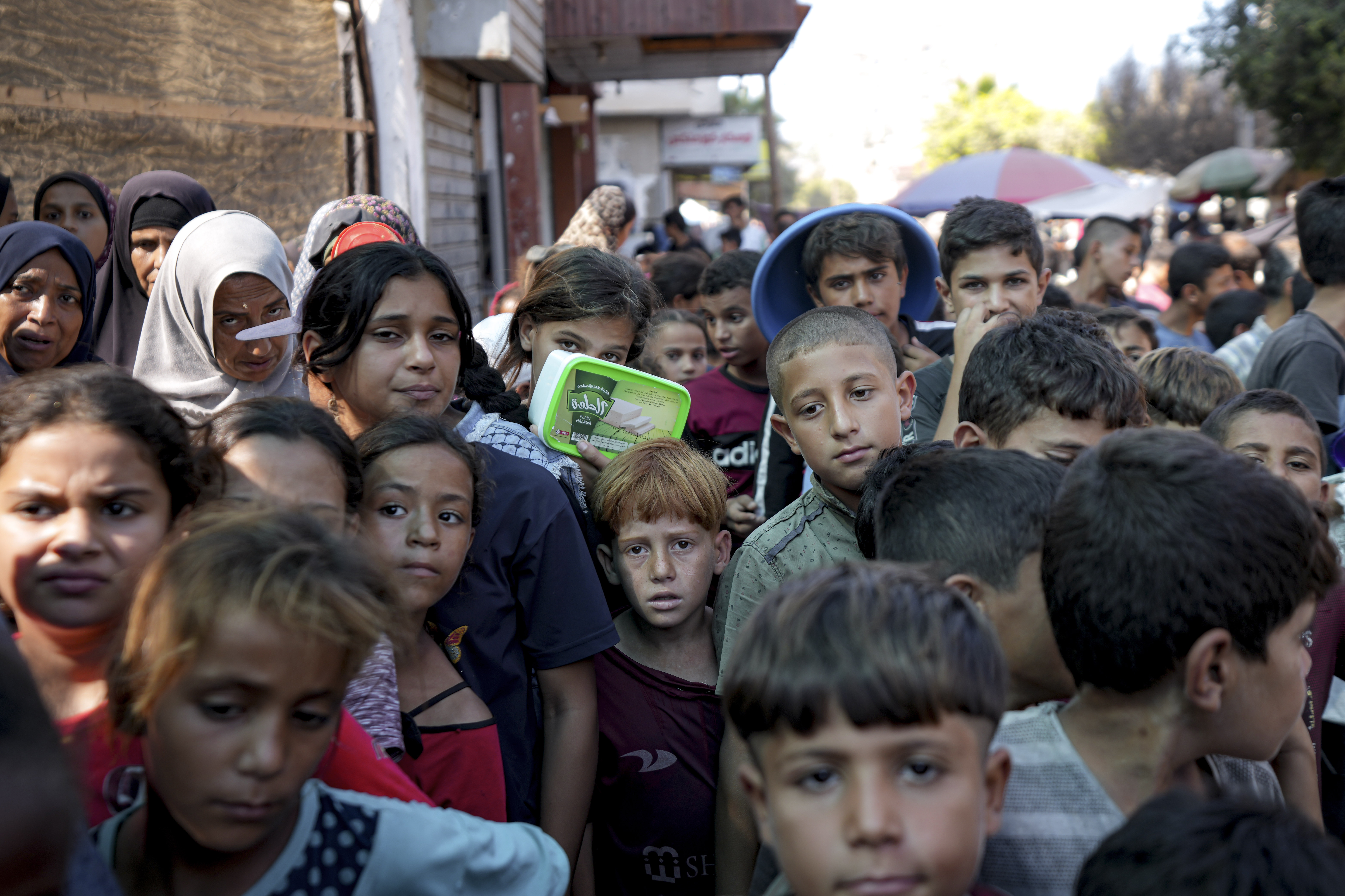 FILE - Palestinians line up for food distribution in Deir al-Balah, Gaza Strip, on Oct. 17, 2024. (AP Photo/Abdel Kareem Hana, File)