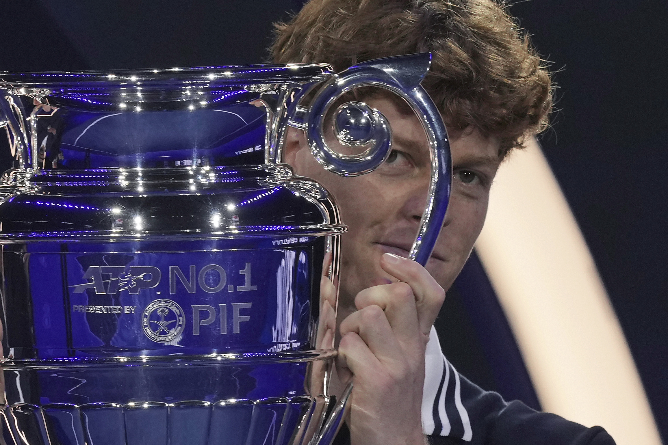 Italy's Jannik Sinner holds the trophy as ATP world best player at the ATP World Tour Finals at the Inalpi Arena, in Turin, Italy, Monday, Nov. 11, 2024. Sinner was presented with the trophy for finishing the year ranked No. 1. (AP Photo/Antonio Calanni)