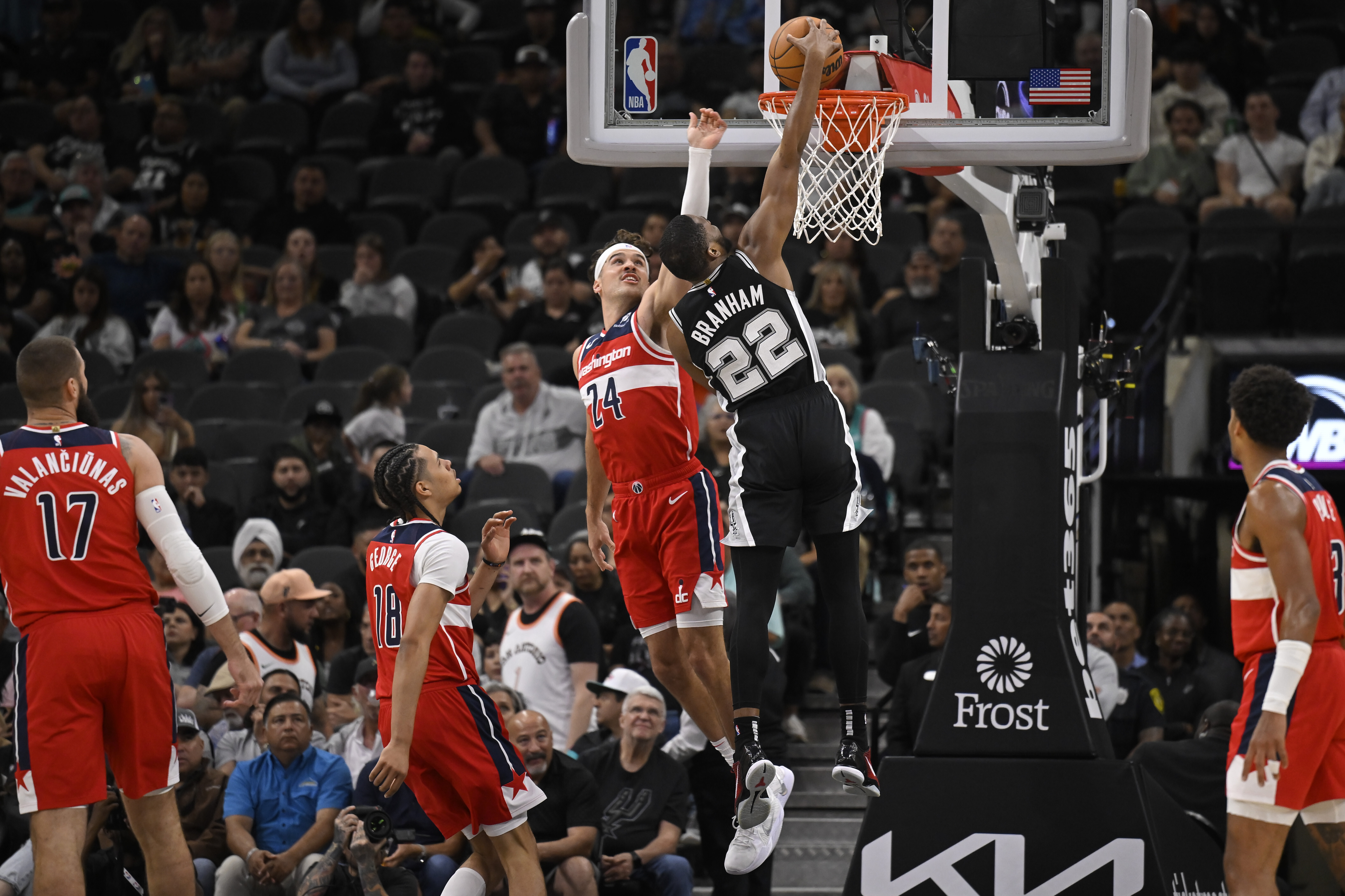 San Antonio Spurs' Malaki Branham (22) dunks against Washington Wizards' Corey Kispert (24) during the first half of an NBA basketball game, Wednesday, Nov. 13, 2024, in San Antonio. (AP Photo/Darren Abate)