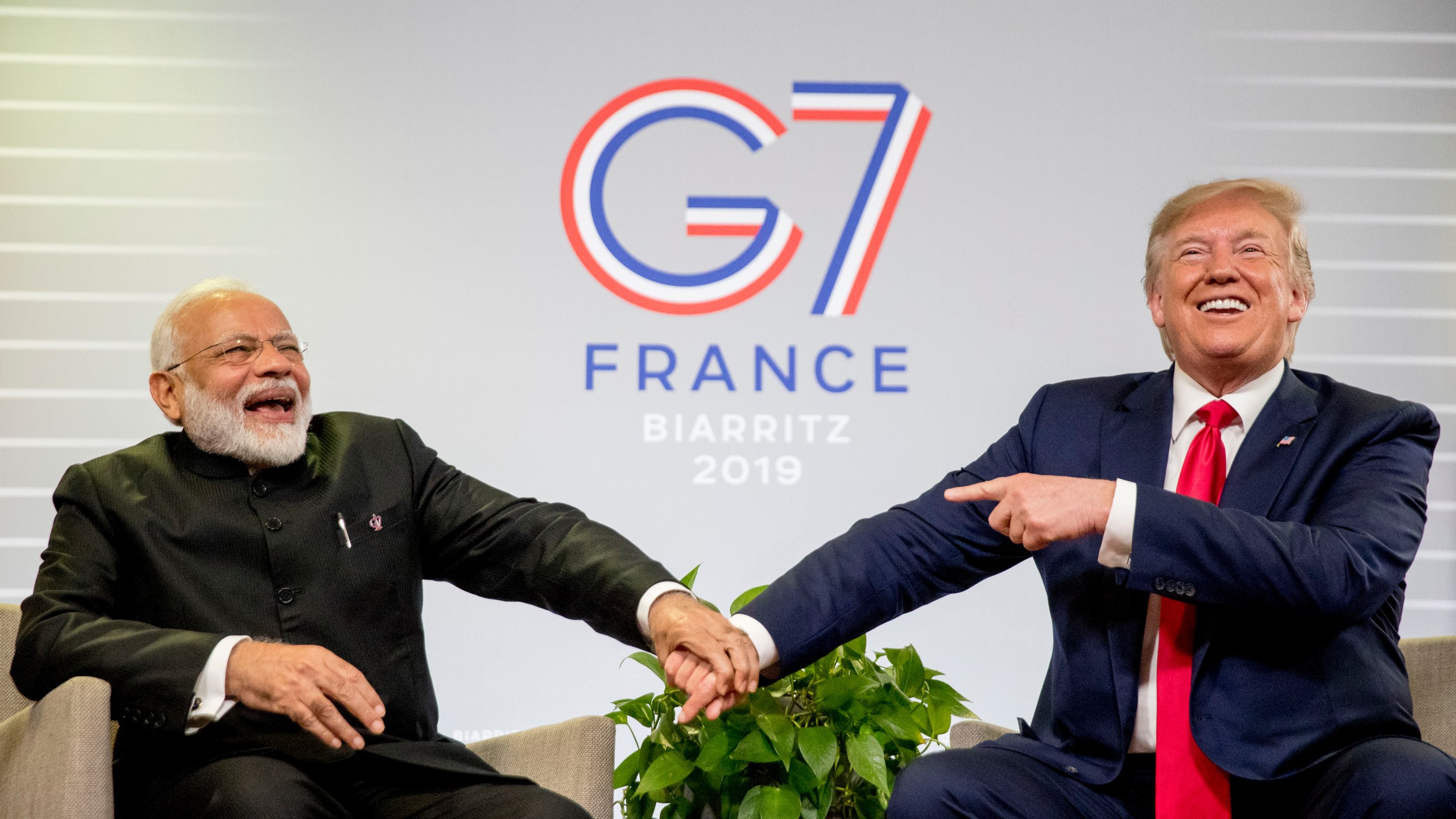 FILE- President Donald Trump and Indian Prime Minister Narendra Modi, left, share a laugh together during a bilateral meeting at the G-7 summit in Biarritz, France, Aug. 26, 2019. (AP Photo/Andrew Harnik, File)