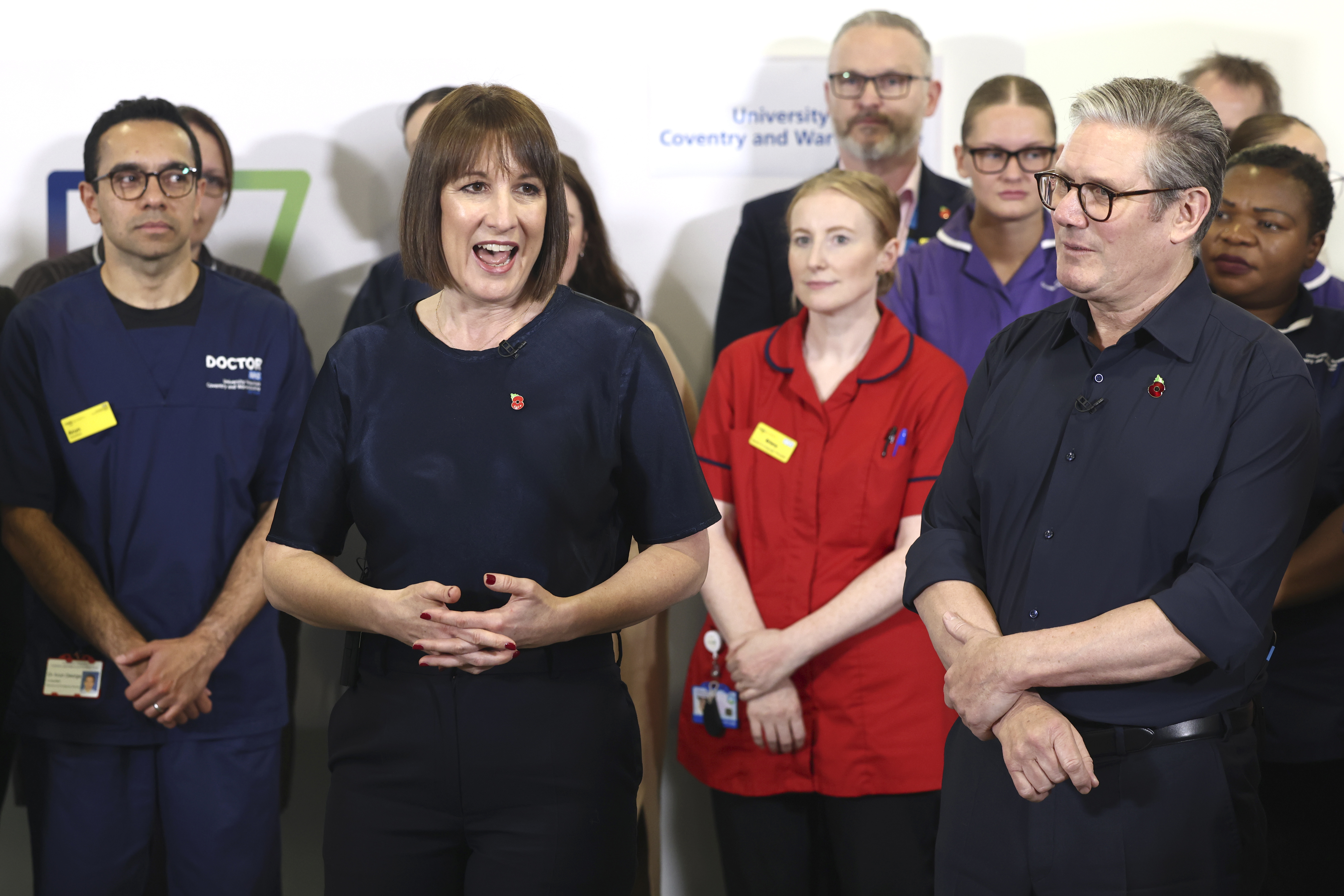 Britain's Prime Minister Keir Starmer and Chancellor Rachel Reeves speak with members of staff, during a visit to University Hospital Coventry and Warwickshire, in Coventry, England, Thursday, Oct. 31, 2024. (AP Photo/Darren Staples, pool)