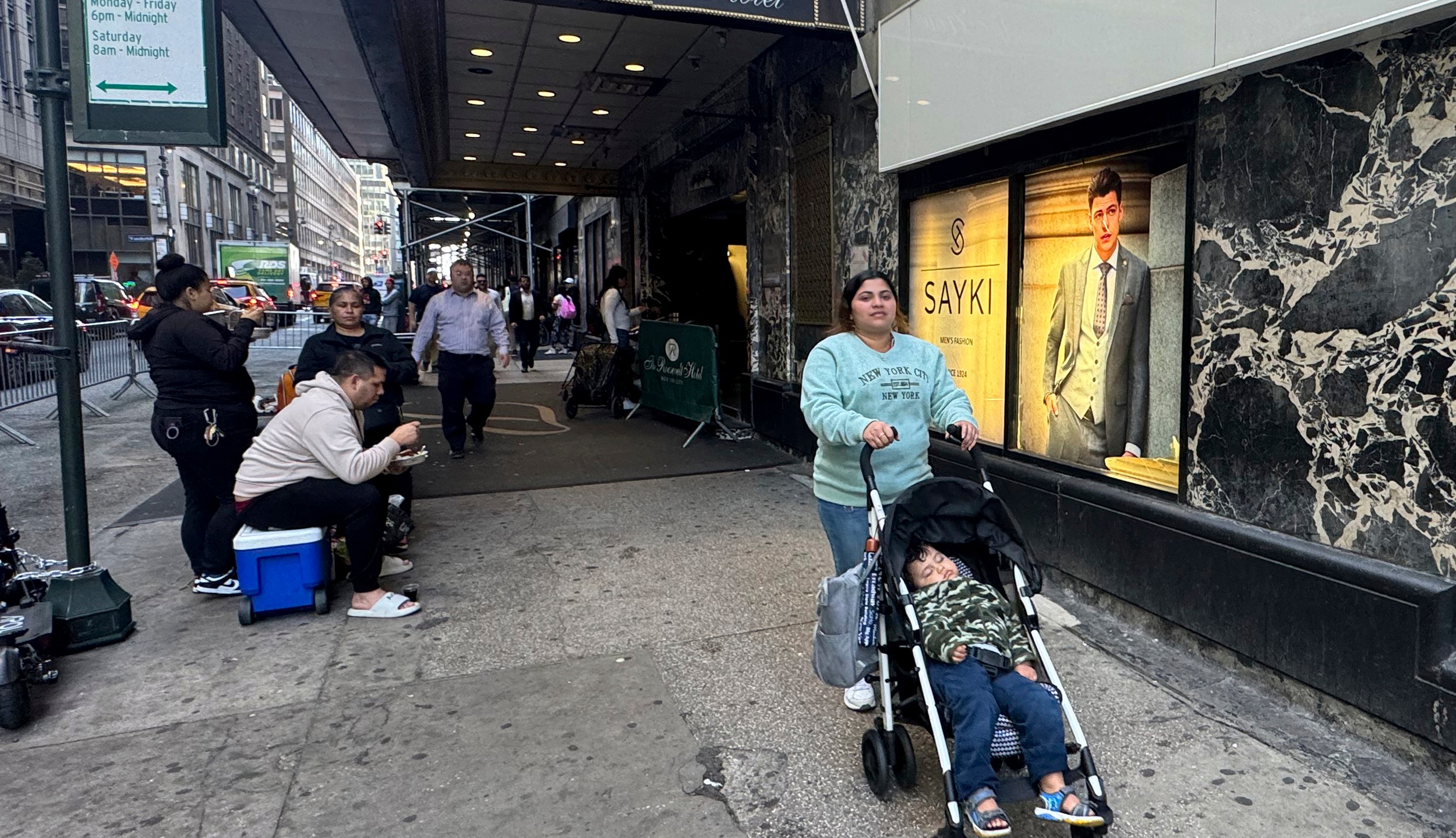 Maribel Hidalgo, 23, an immigrant from Venezuela, pushes a stroller carrying her son, Daniel, 2, outside the Roosevelt Hotel immigration shelter in New York on Wednesday, Nov. 6, 2024. (AP Photo/Cedar Attanasio)