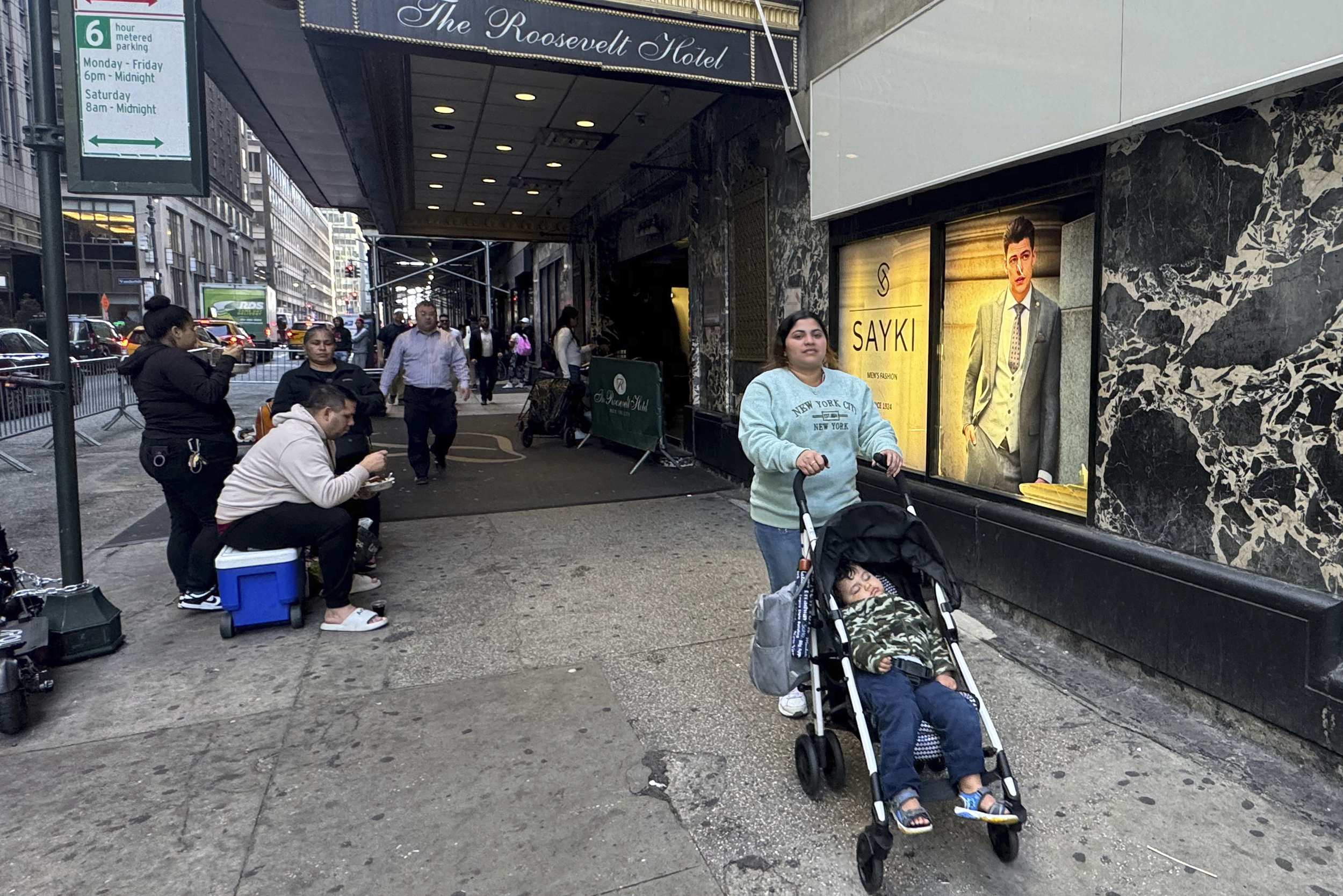 Maribel Hidalgo, 23, an immigrant from Venezuela, pushes a stroller carrying her son, Daniel, 2, outside the Roosevelt Hotel immigration shelter in New York on Wednesday, Nov. 6, 2024. (AP Photo/Cedar Attanasio)