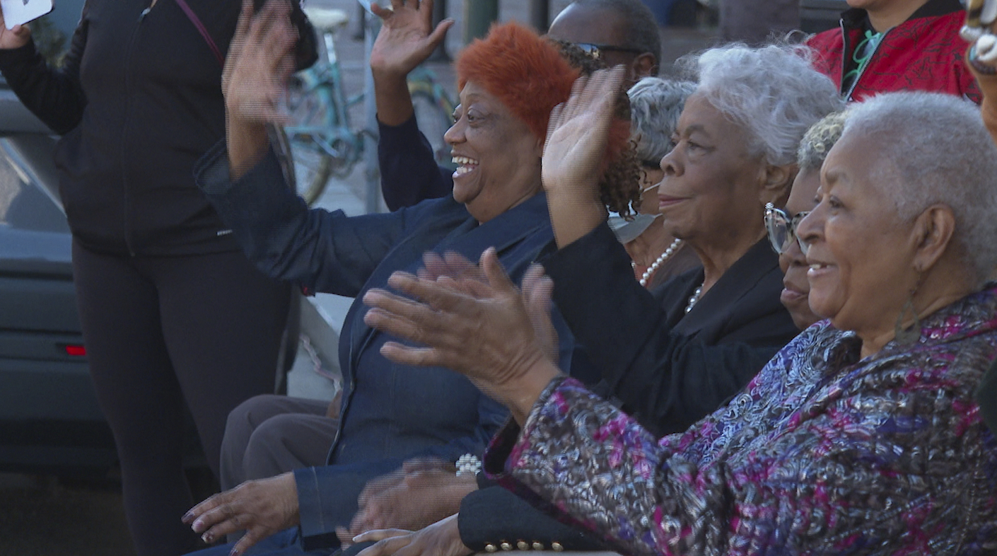 Civil rights activists, from left to right, Gail Etienne, Dorothy Prevost and Dorotha Dodie Smith-Simmons watch marching bands pass by to celebrate the sixty-four-year anniversary of the New Orleans Four desegregating schools Thursday, Nov. 14, 2024, in New Orleans. (AP Photo/Stephen Smith)