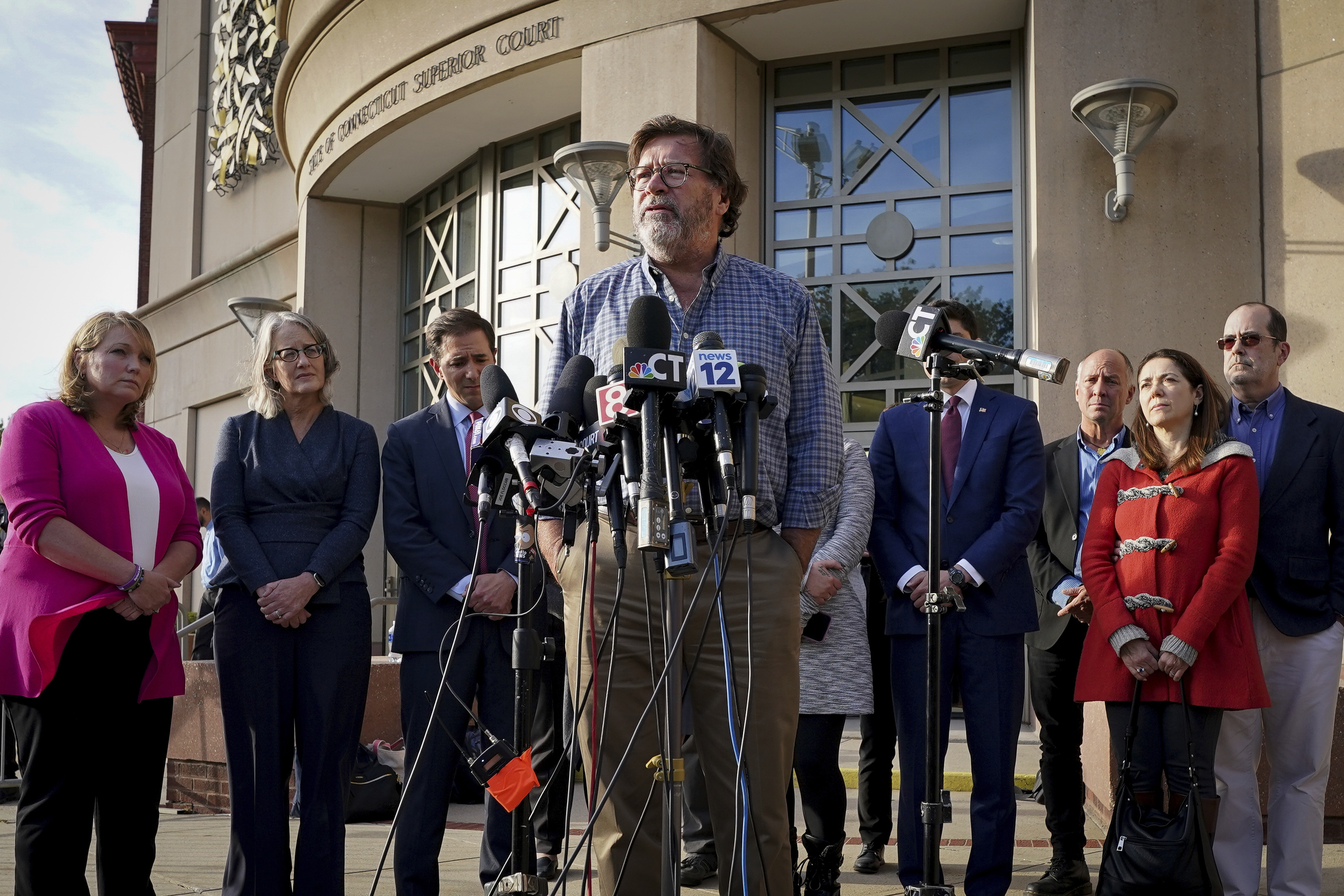 FILE - Bill Sherlach, husband of Mary, one of the Sandy Hook School shooting victims, speaks to the media after jurors returned a $965 million dollar judgement in the defamation trial against Alex Jones, in Waterbury, Conn., Oct. 12, 2022. (AP Photo/Bryan Woolston, File)