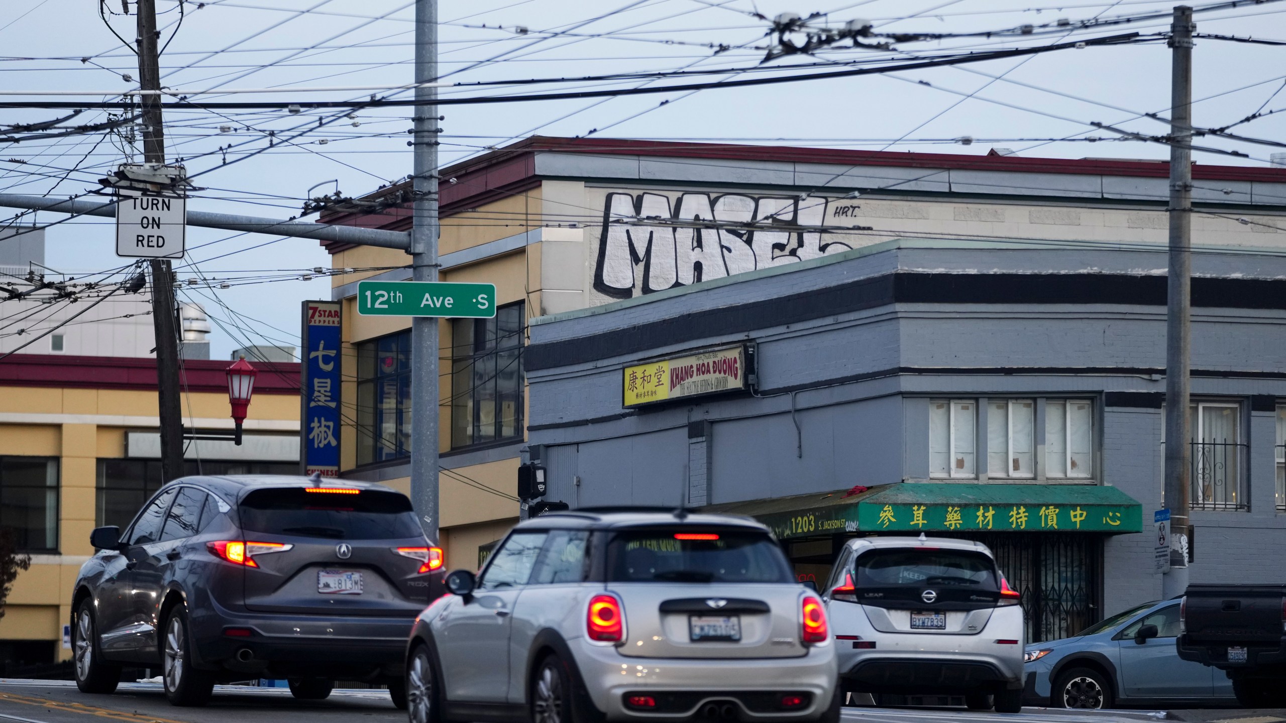 Drivers move through the area where multiple people were stabbed earlier Friday, Nov. 8, 2024, in the Chinatown-International District in Seattle. (AP Photo/Lindsey Wasson)