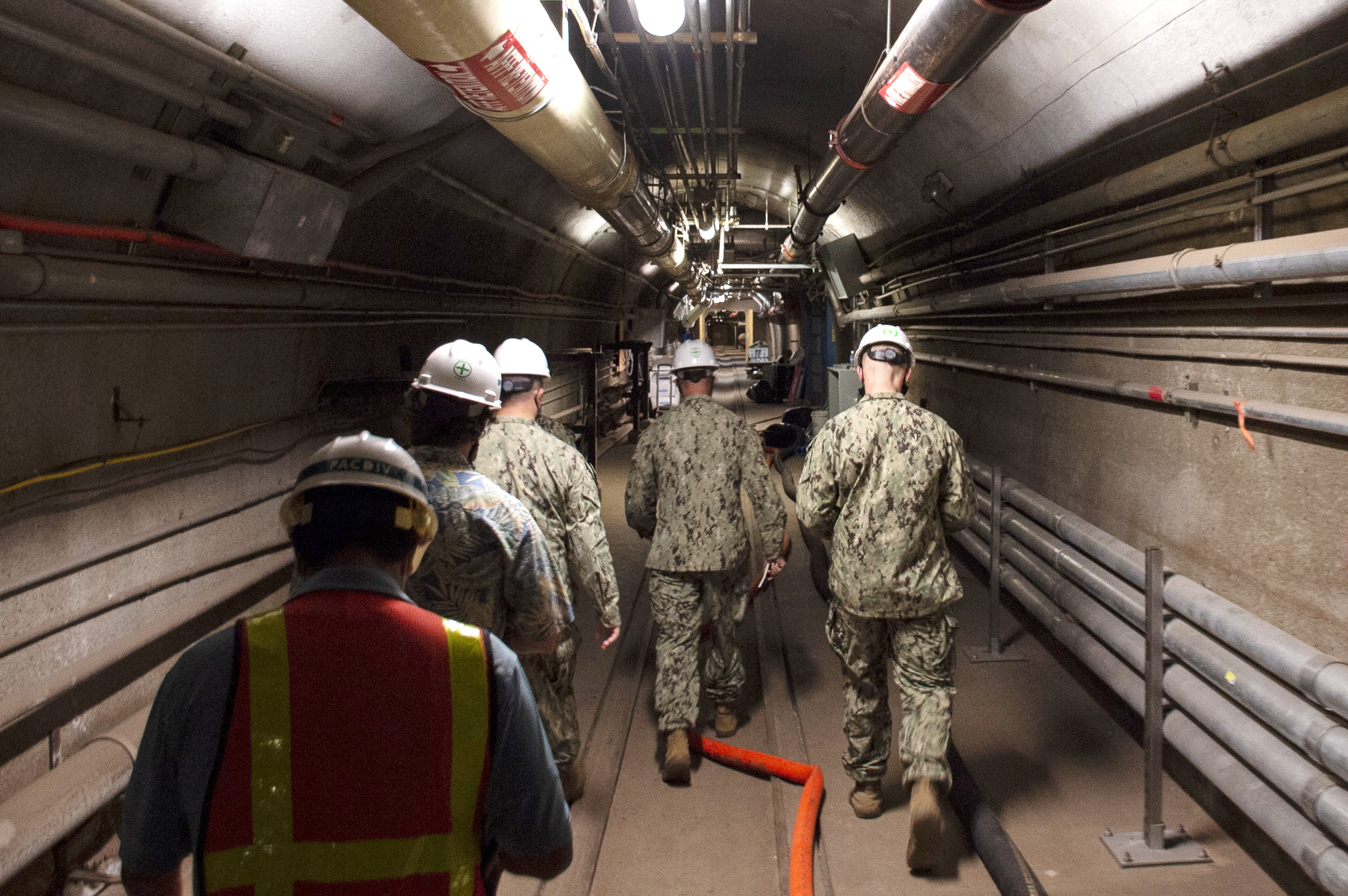 FILE - In this photo provided by the U.S. Navy, Rear Adm. John Korka, Commander, Naval Facilities Engineering Systems Command (NAVFAC), and Chief of Civil Engineers, leads Navy and civilian water quality recovery experts through the tunnels of the Red Hill Bulk Fuel Storage Facility, near Pearl Harbor, Hawaii, on Dec. 23, 2021. (Mass Communication Specialist 1st Class Luke McCall/U.S. Navy via AP, File)