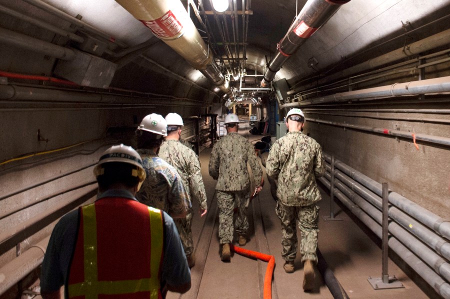 FILE - In this photo provided by the U.S. Navy, Rear Adm. John Korka, Commander, Naval Facilities Engineering Systems Command (NAVFAC), and Chief of Civil Engineers, leads Navy and civilian water quality recovery experts through the tunnels of the Red Hill Bulk Fuel Storage Facility, near Pearl Harbor, Hawaii, on Dec. 23, 2021. (Mass Communication Specialist 1st Class Luke McCall/U.S. Navy via AP, File)