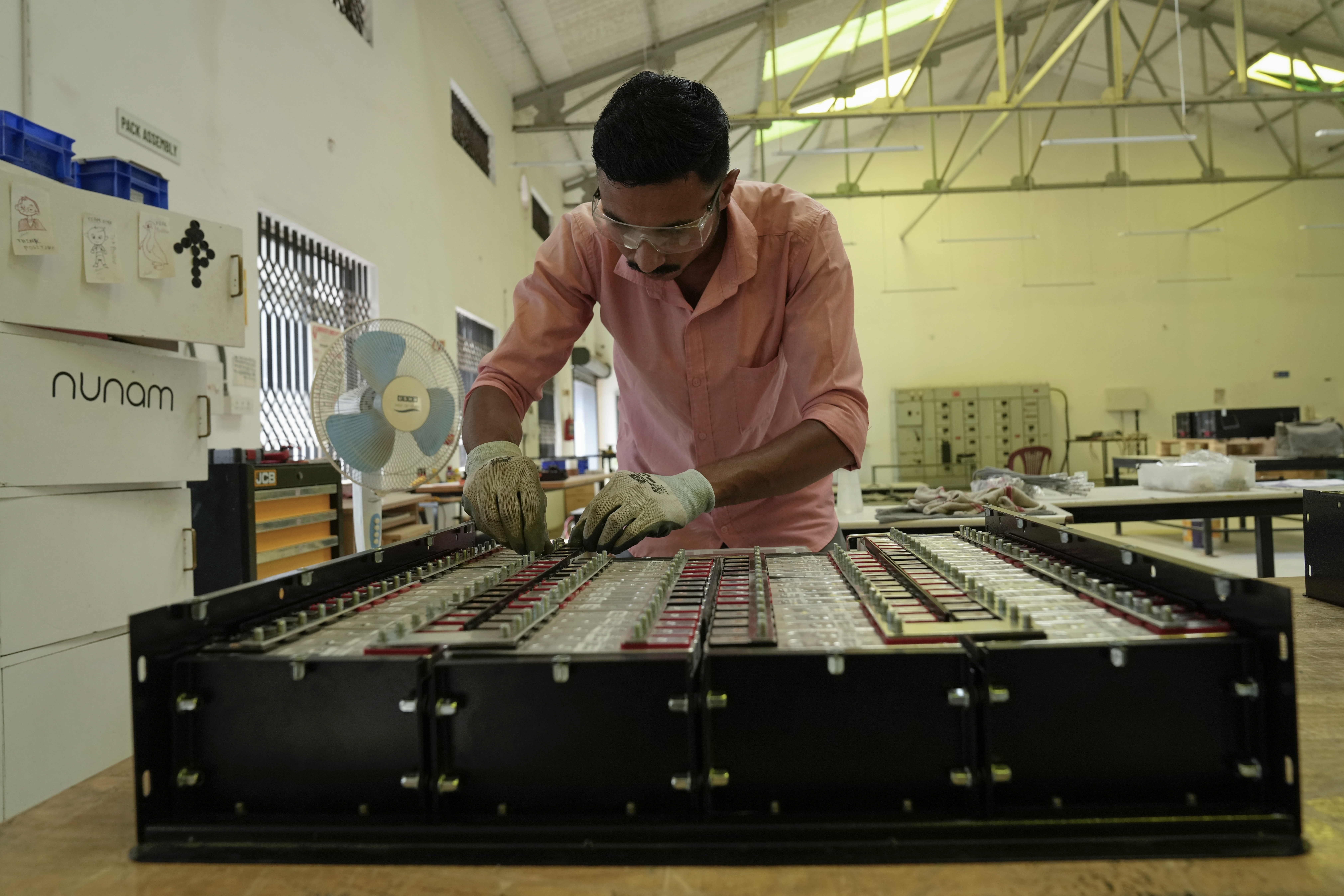 Sandip Varute, a battery production engineer at Nunam, assembles a refurbished battery pack, made from used electric vehicle batteries, at their facility in Bengaluru, India, Tuesday, Oct. 8, 2024. (AP Photo/Aijaz Rahi)