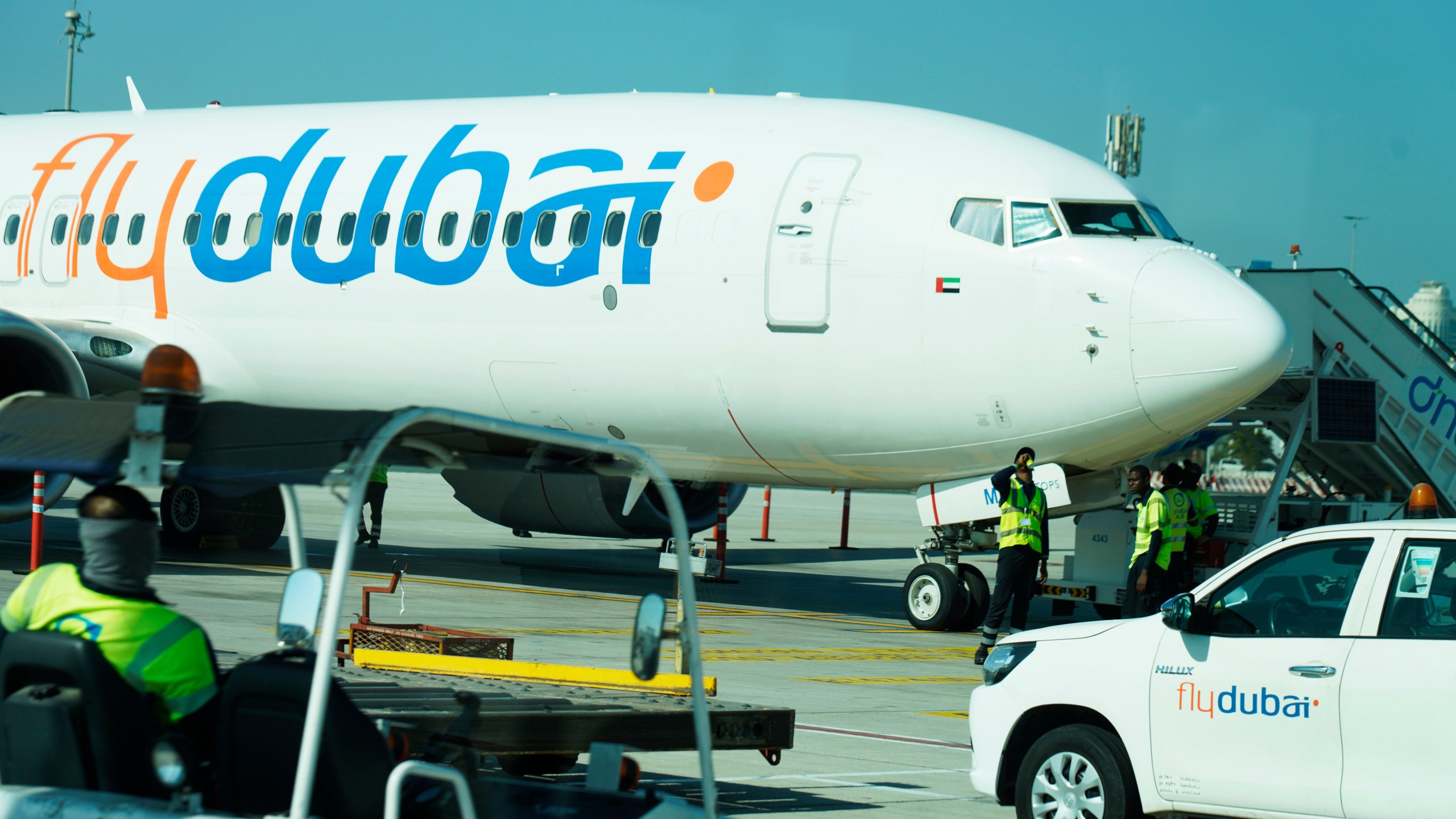 Workers prepare a FlyDubai flight at Dubai International Airport in Dubai, United Arab Emirates, Friday, Oct. 18, 2024. (AP Photo/Jon Gambrell)