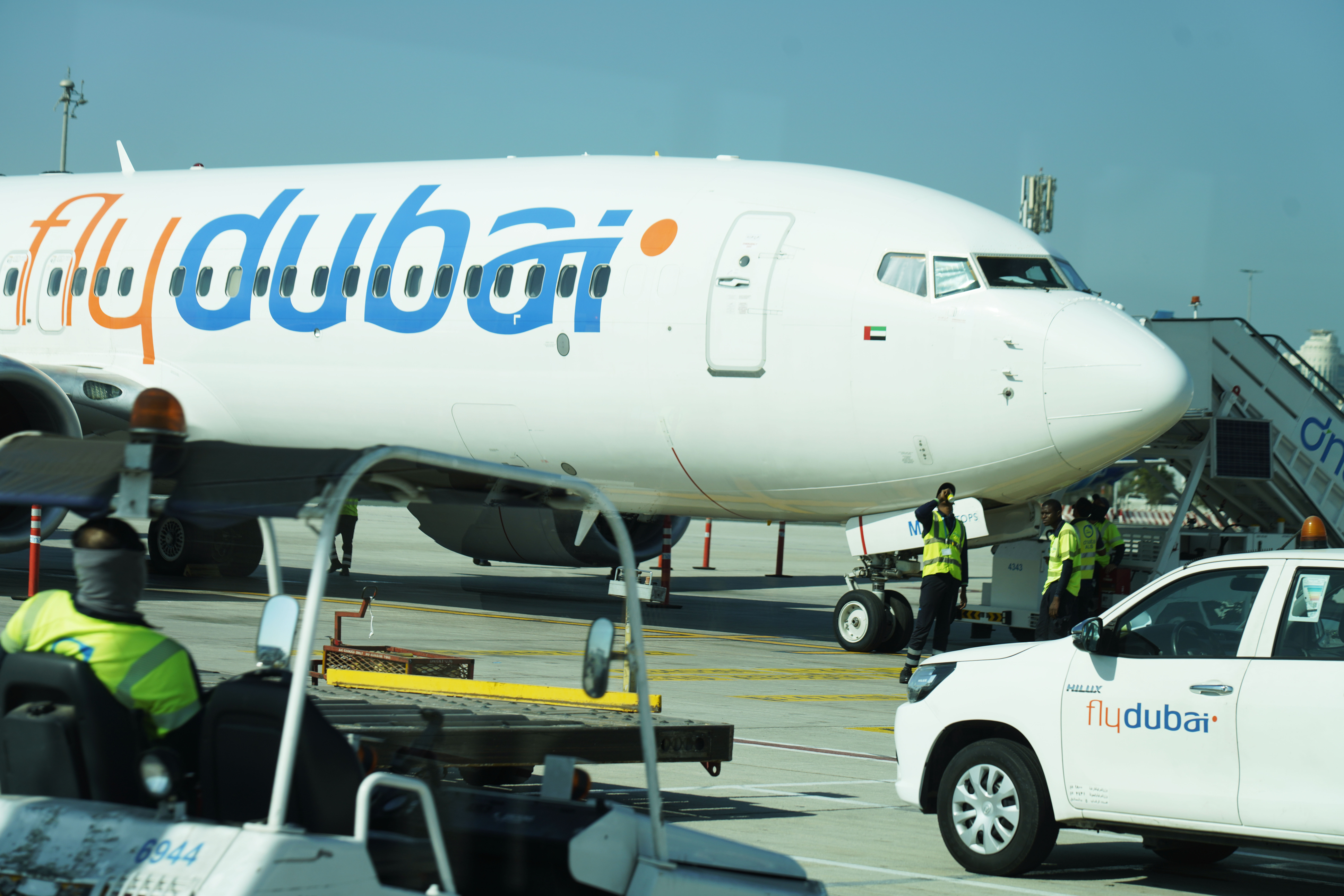 Workers prepare a FlyDubai flight at Dubai International Airport in Dubai, United Arab Emirates, Friday, Oct. 18, 2024. (AP Photo/Jon Gambrell)