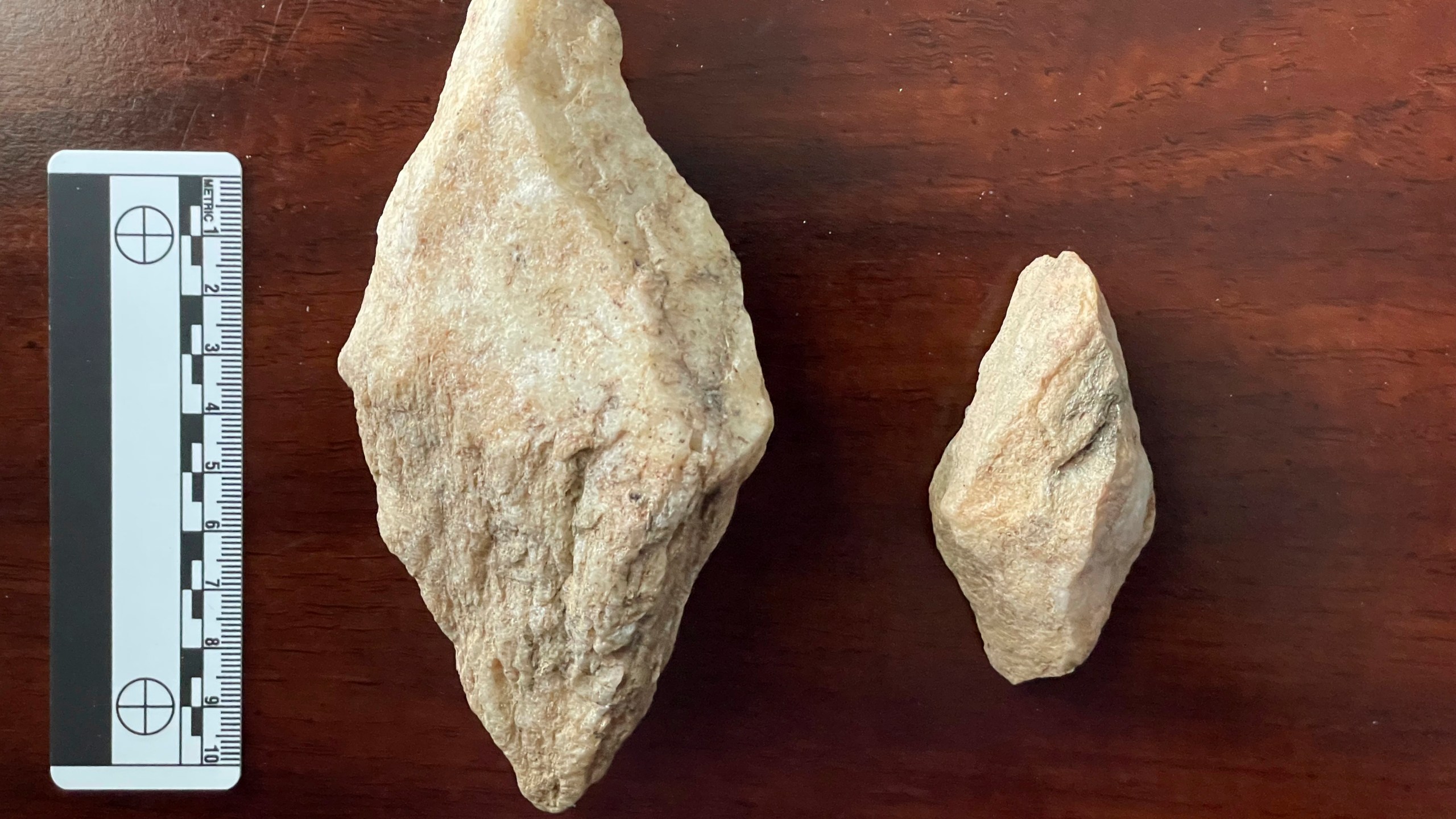 This undated photo provided by Philip LaPorta shows two bipointed quarry picks fashioned from quartz mylonite that were uncovered during an archaeological survey of the Seniard Creek Fire scar south of Asheville, North Carolina. (Philip LaPorta via AP)