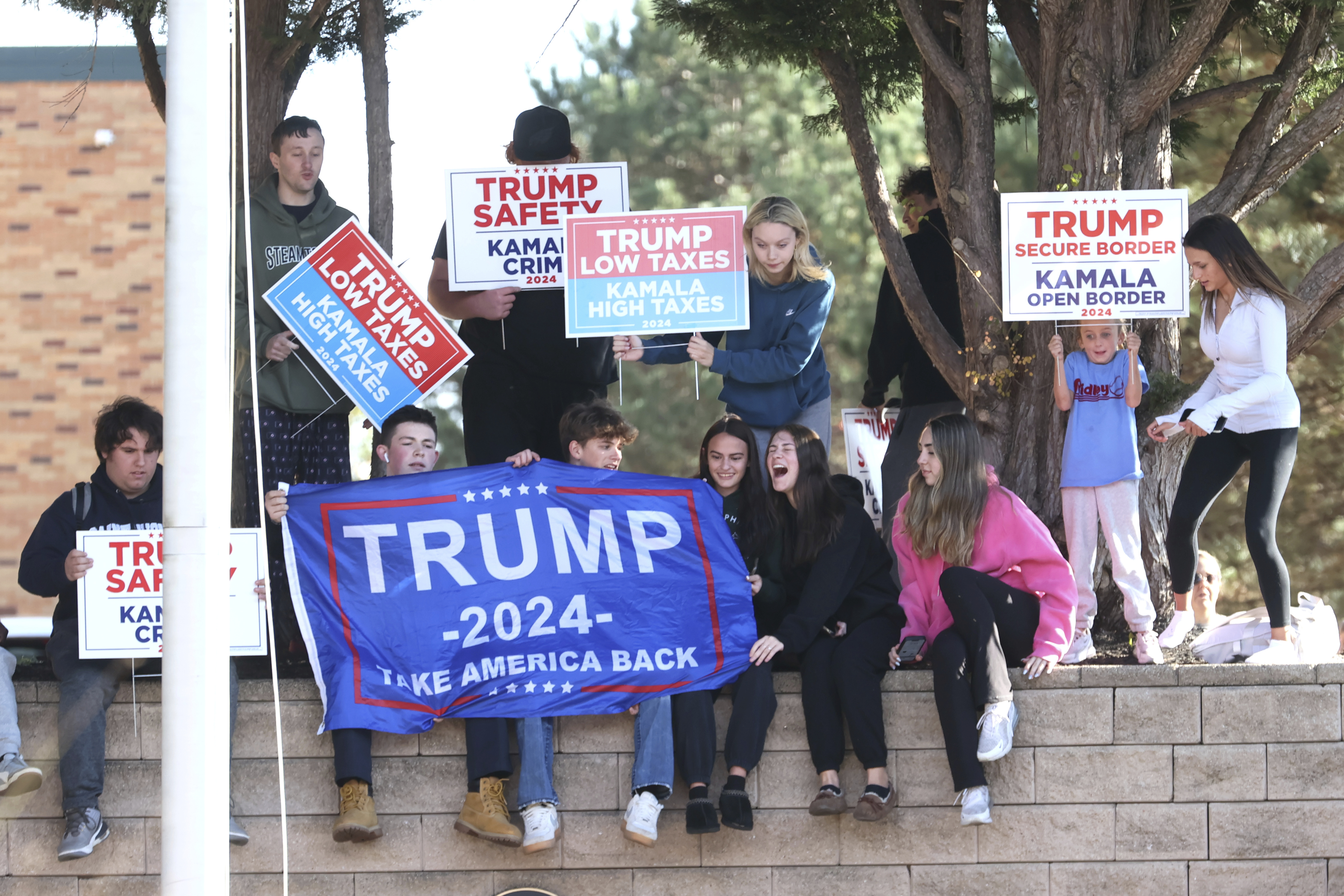 Young Trump supporters gather outside Ridley High School before Elon Musk leads a America PAC Town Hall in Delaware County, Pa., at Ridley High School on Thursday, Oct. 17, 2024. (Charles Fox/The Philadelphia Inquirer via AP)