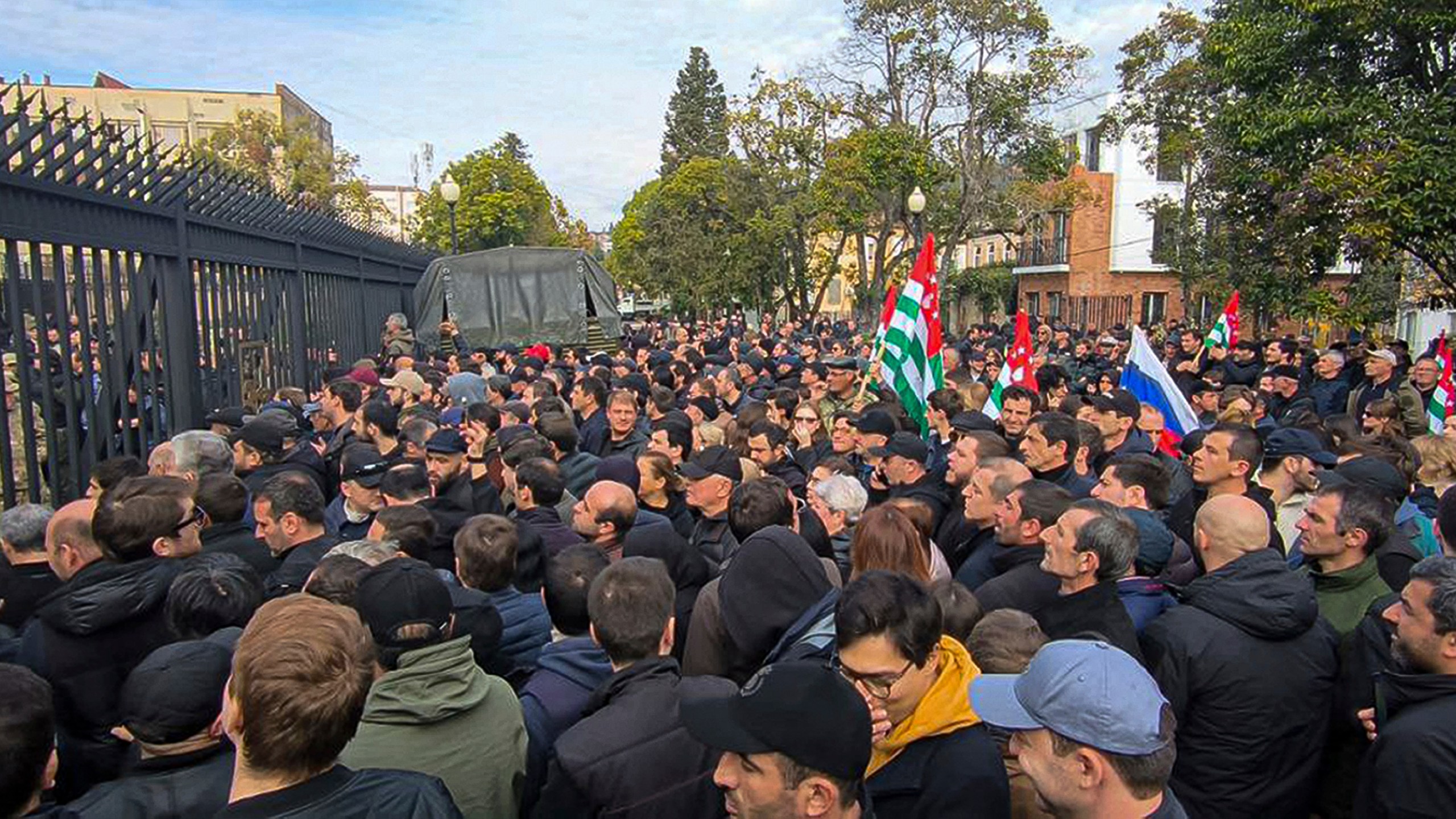 In this photo taken from video released by AIASHARA Independent Agency, Protesters gather outside the parliament building of the Georgian separatist region of Abkhazia as tensions flared over a proposed pact that would allow Russians to buy apartments in the region, Georgia, on Friday, Nov. 15, 2024. (AIASHARA Independent Agency via AP)