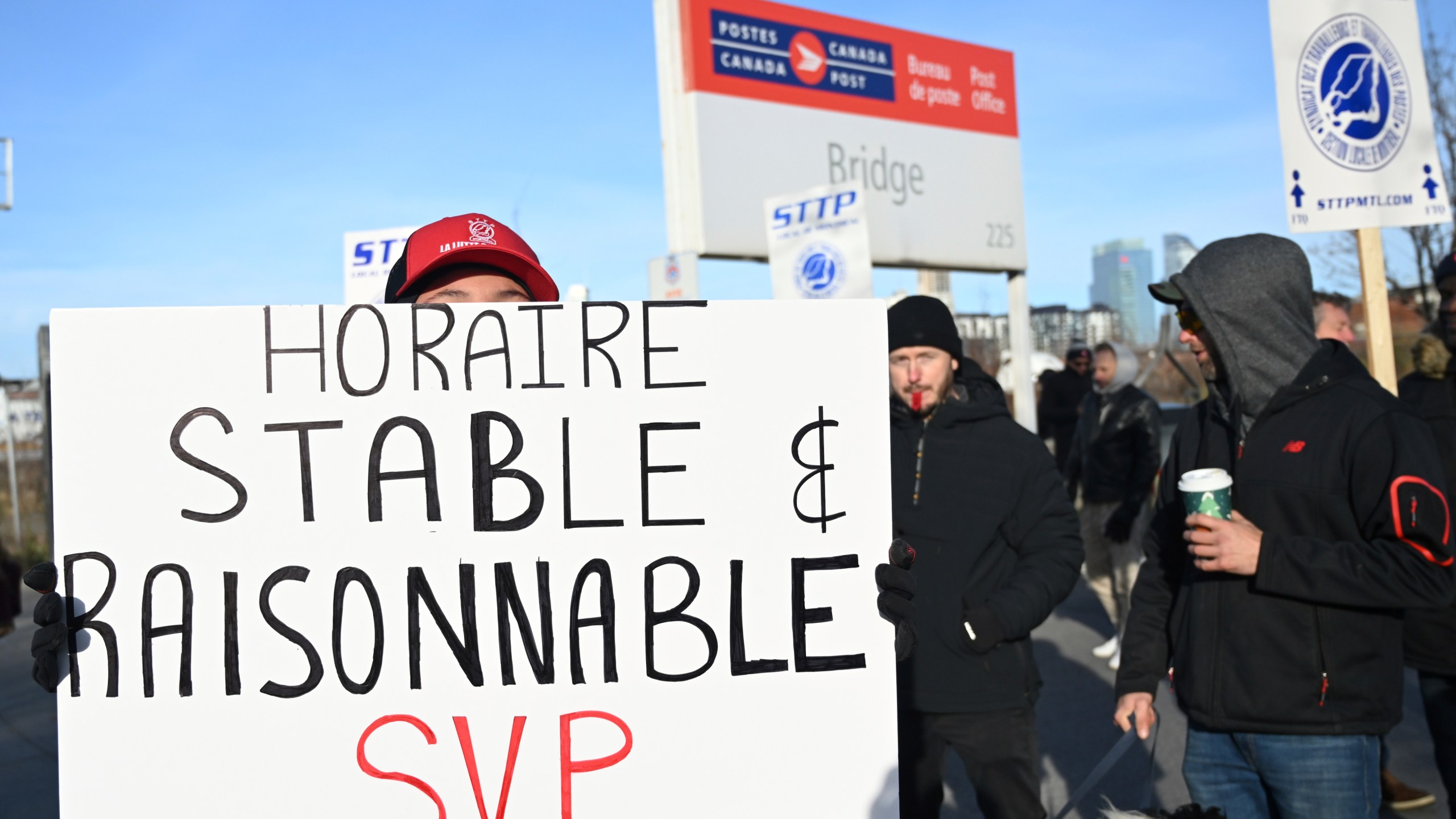 Canada Post workers picket outside a sorting plant in Montreal on Friday, Nov.15, 2024. (Graham Hughes /The Canadian Press via AP)