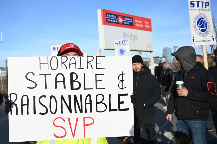 Canada Post workers picket outside a sorting plant in Montreal on Friday, Nov.15, 2024. (Graham Hughes /The Canadian Press via AP)