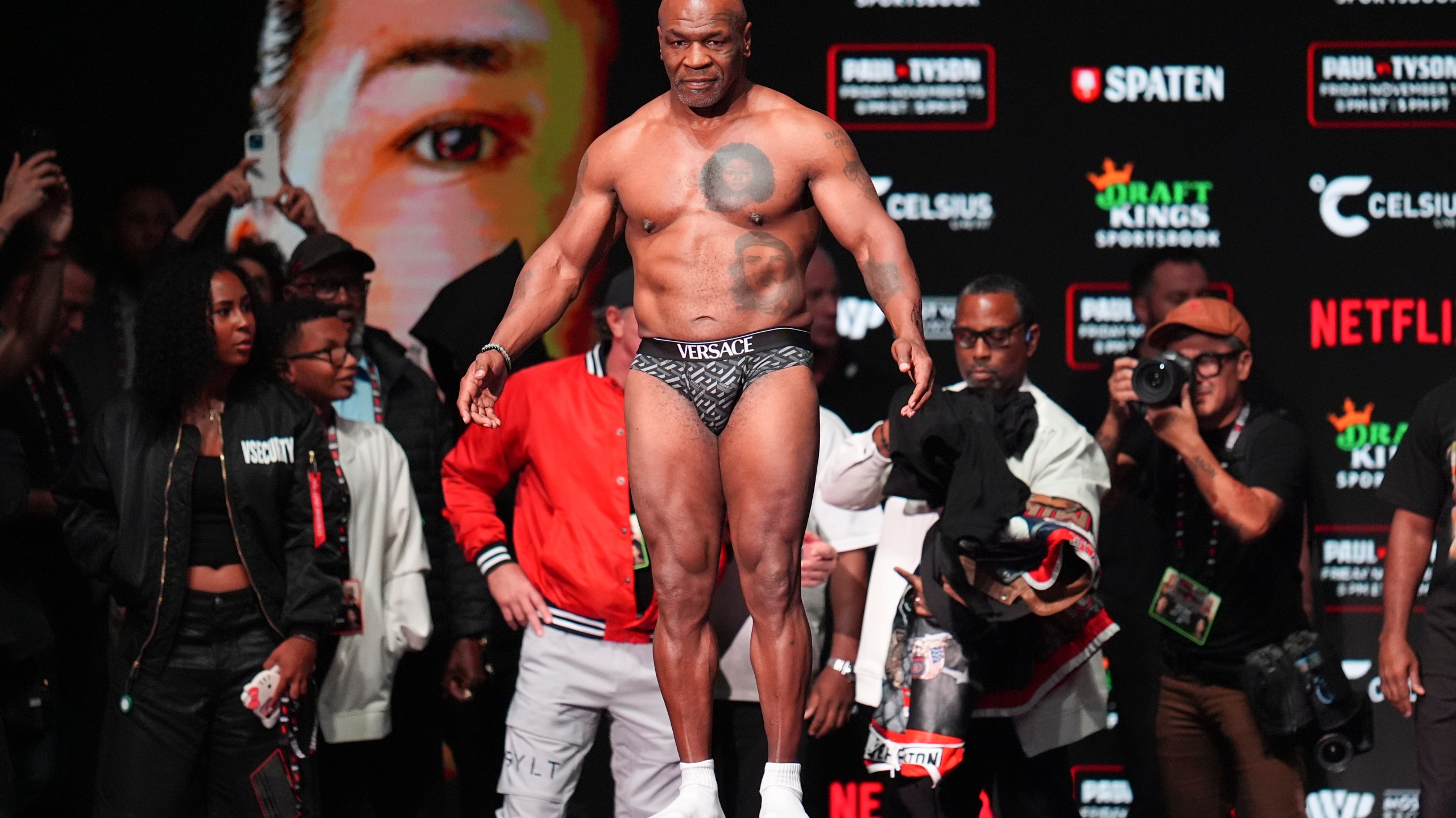 Mike Tyson steps on the scale during a weigh-in ahead of his heavyweight bout against Jake Paul, Thursday, Nov. 14, 2024, in Irving, Texas. (AP Photo/Julio Cortez)