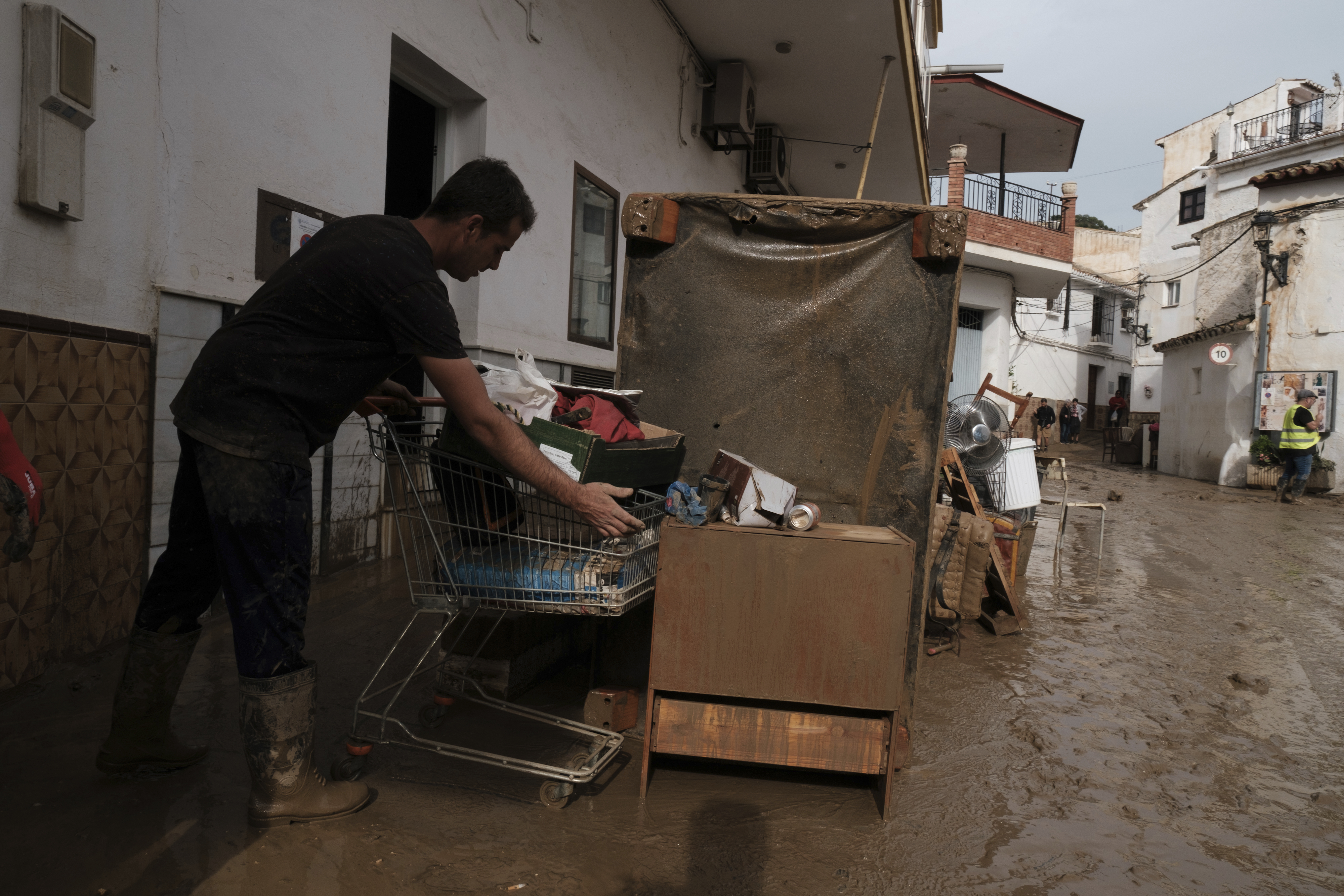 Residents remove their belongings from their houses affected by flooding in Benagarmosa, Malaga, Spain, Thursday, Nov. 14, 2024. (AP Photo/Gregorio Marrero)