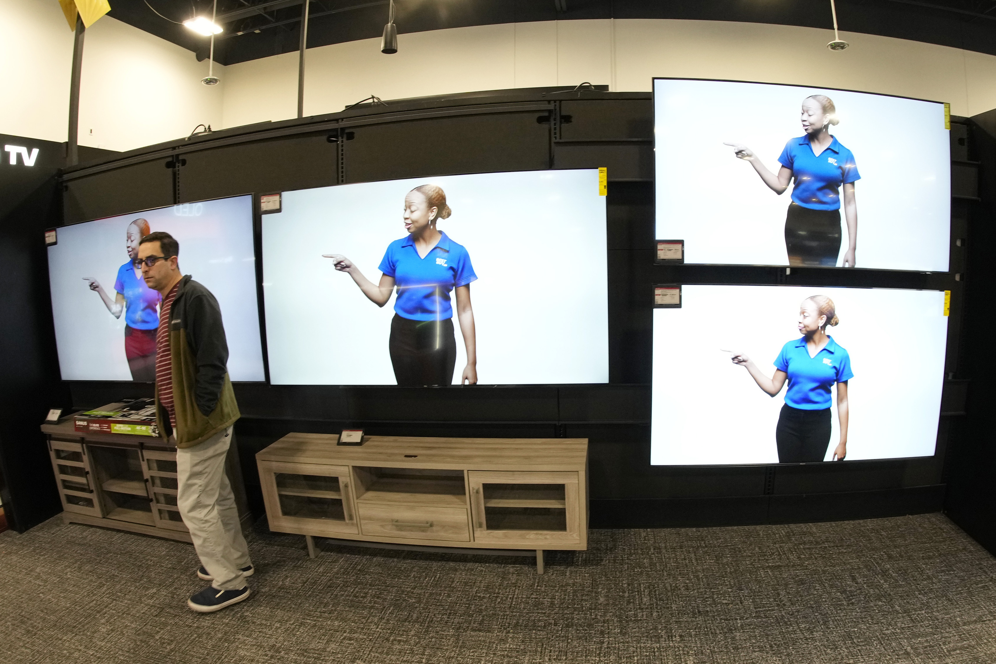 FILE - A customer turns away after looking at big-screen televisions in a Best Buy store Nov. 21, 2023, in southeast Denver. (AP Photo/David Zalubowski, File)