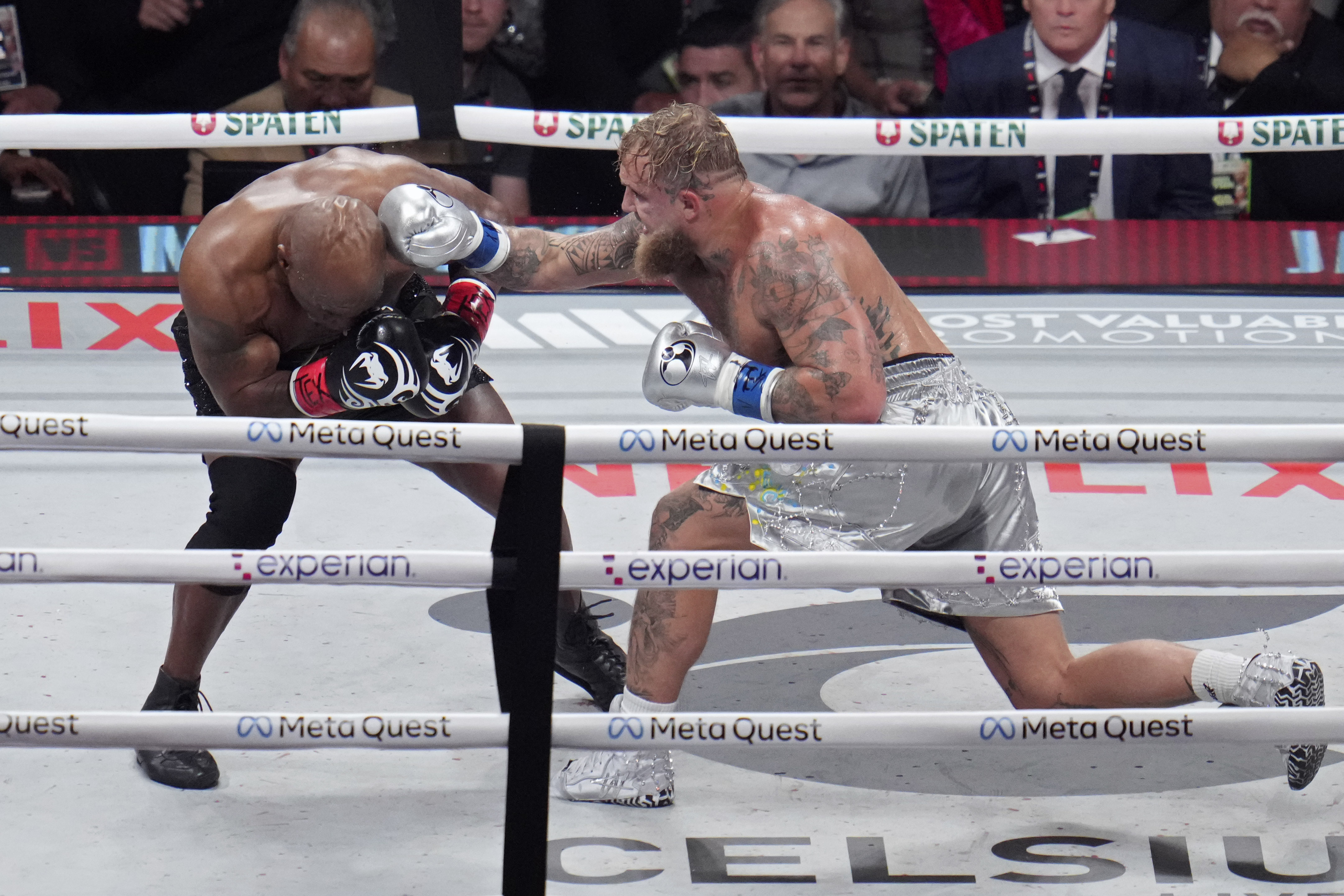 Jake Paul hits Mike Tyson during their heavyweight boxing match, Friday, Nov. 15, 2024, in Arlington, Texas. (AP Photo/Julio Cortez)