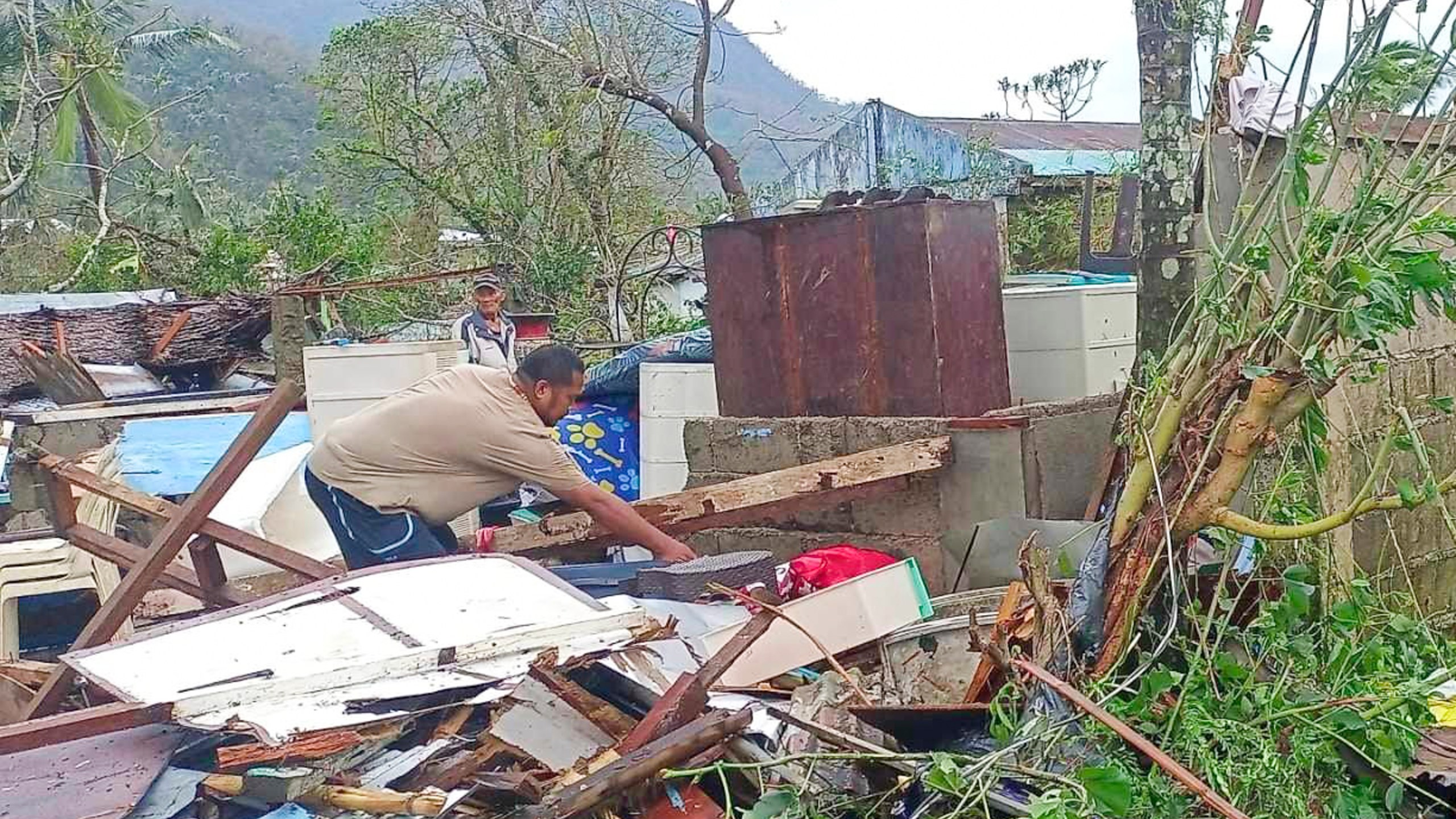 In this photo provided by the MDRRMO Viga Catanduanes, a resident recovers belongings from their damaged homes caused by Typhoon Man-yi in Viga, Catanduanes province, northeastern Philippines Sunday, Nov. 17, 2024. (MDRRMO Viga Catanduanes via AP)