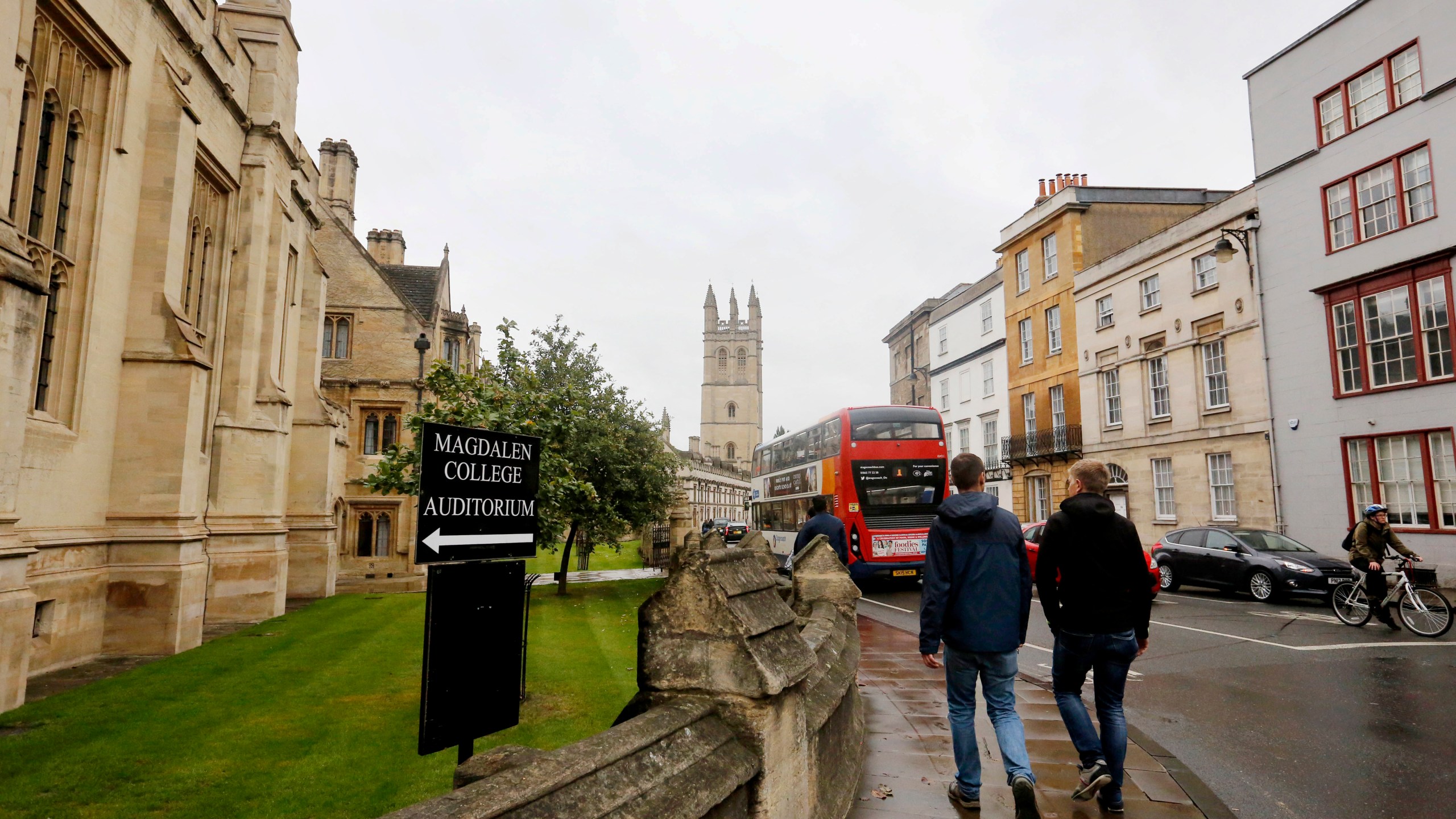 FILE - People walk around Oxford University's campus on Sept. 3, 2017, in Oxford, England. (AP Photo/Caroline Spiezio, File)