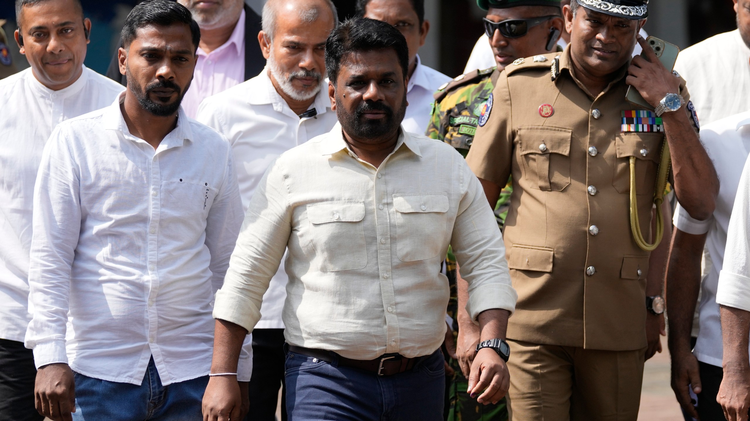 Sri Lankan President Anura Kumara Dissanayake, center, leaves after casting his vote during the parliamentary election in Colombo, Sri Lanka, Thursday, Nov. 14, 2024.(AP Photo/Eranga Jayawardena)