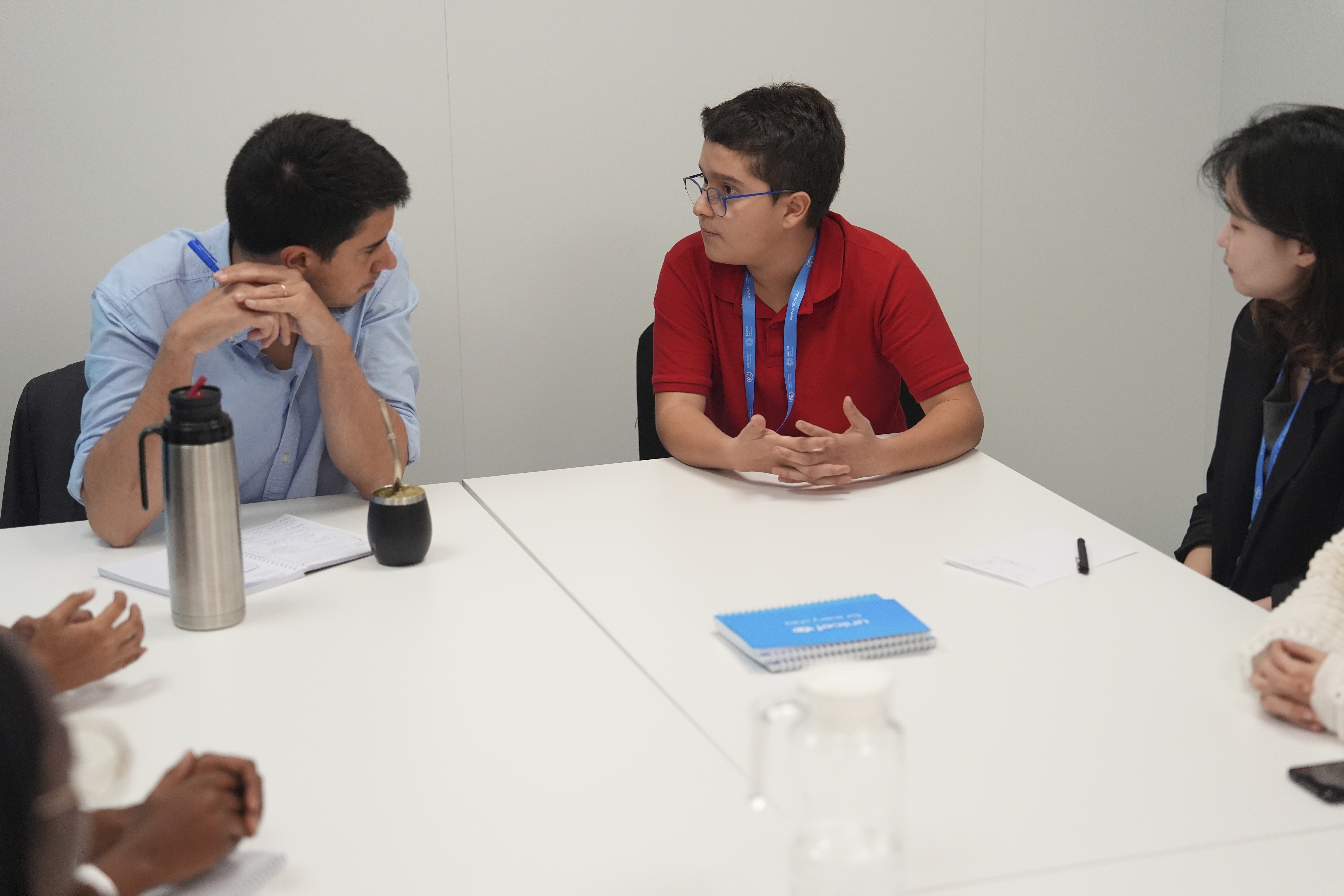 Francisco Vera Manzanares, 15, center, a climate activist from Colombia, speaks with Felipe Paullier, left, U.N. assistant secretary-general for youth affairs, during a forum with young activists, Tuesday, Nov. 12, 2024, at the COP29 U.N. Climate Summit in Baku, Azerbaijan. (AP Photo/Joshua A. Bickel)