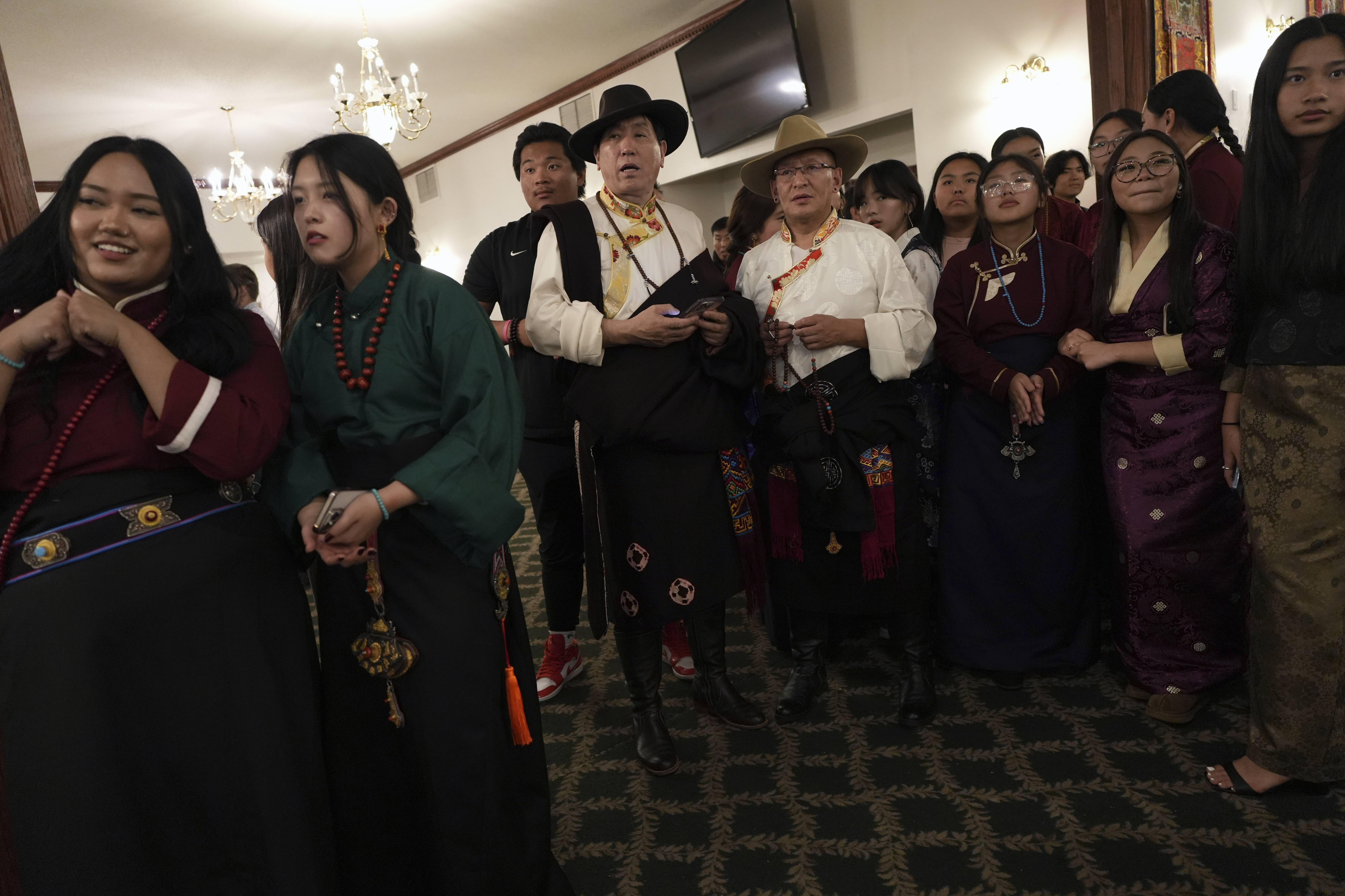 Guests prepare to welcome U.S.-born Buddhist lama, Jalue Dorje, during his 18th birthday and enthronement ceremony at the Tibetan American Foundation of Minnesota in Isanti, Minn., on Saturday, Nov. 9, 2024. (AP Photo/Luis Andres Henao)