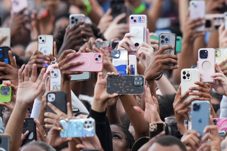 Supporters of Vice President Kamala Harris hold up their phones as she delivers a concession speech for the 2024 presidential election, Wednesday, Nov. 6, 2024, on the campus of Howard University in Washington. (AP Photo/Stephanie Scarbrough)