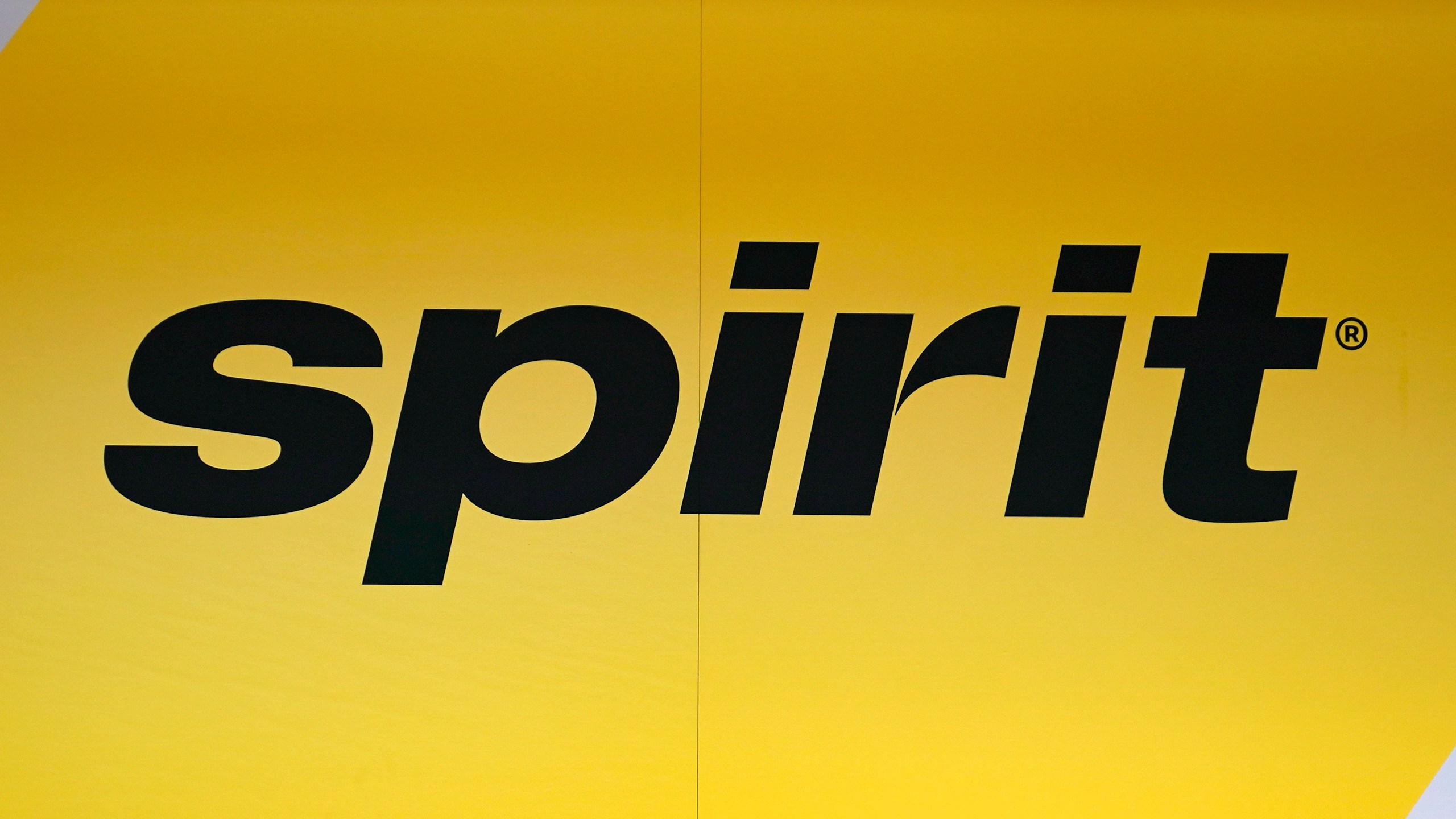 FILE - The Spirit Airlines logo is seen at the ticket counter at Manchester Boston Regional Airport, on June 2, 2023, in Manchester, N.H. (AP Photo/Charles Krupa, File)