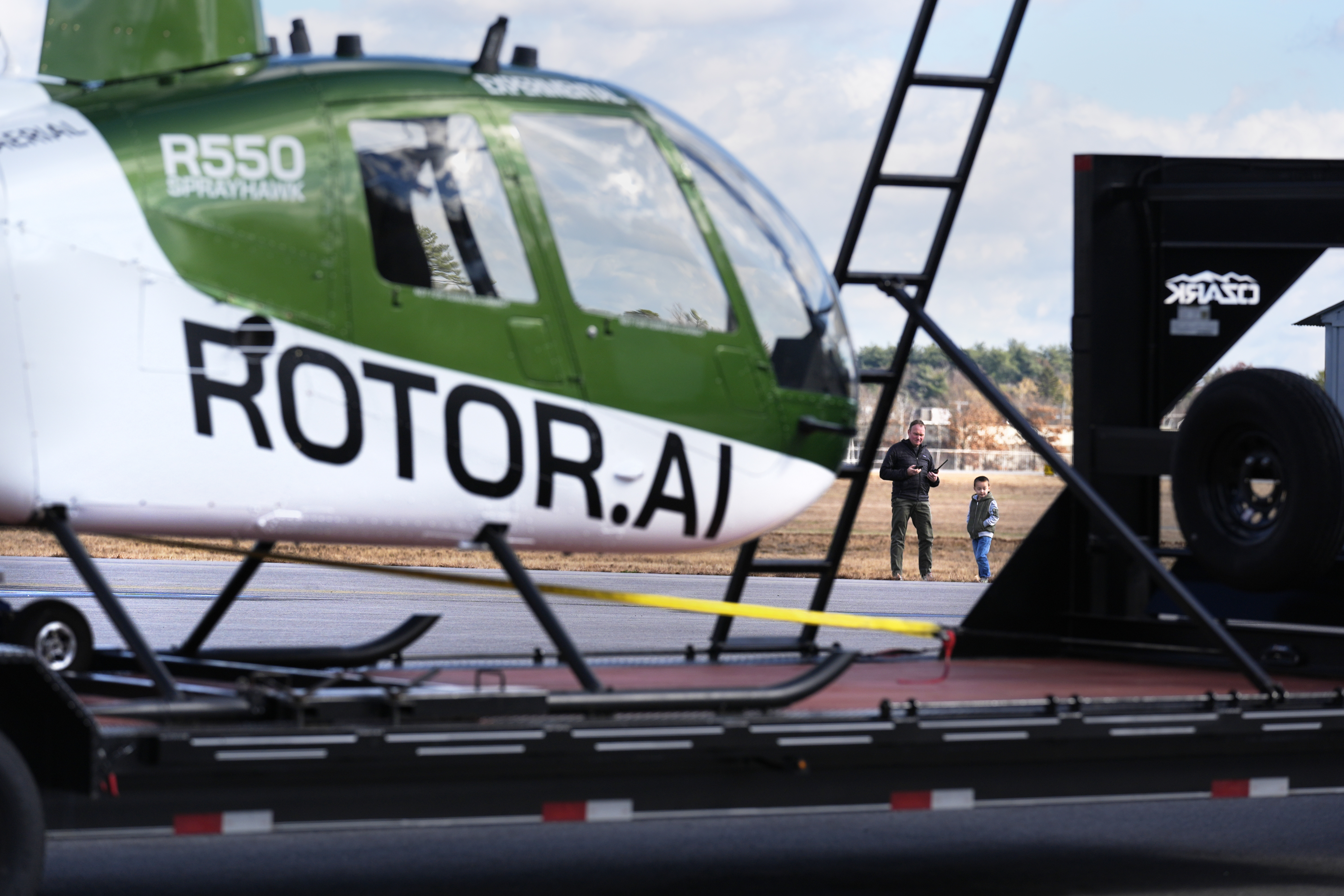 Christian Nowosiadly and his son Logan, 5, watches as a a hanger at the Rotor Technologies , Monday, Nov. 11, 2024, in Nashua, N.H. (AP Photo/Charles Krupa)