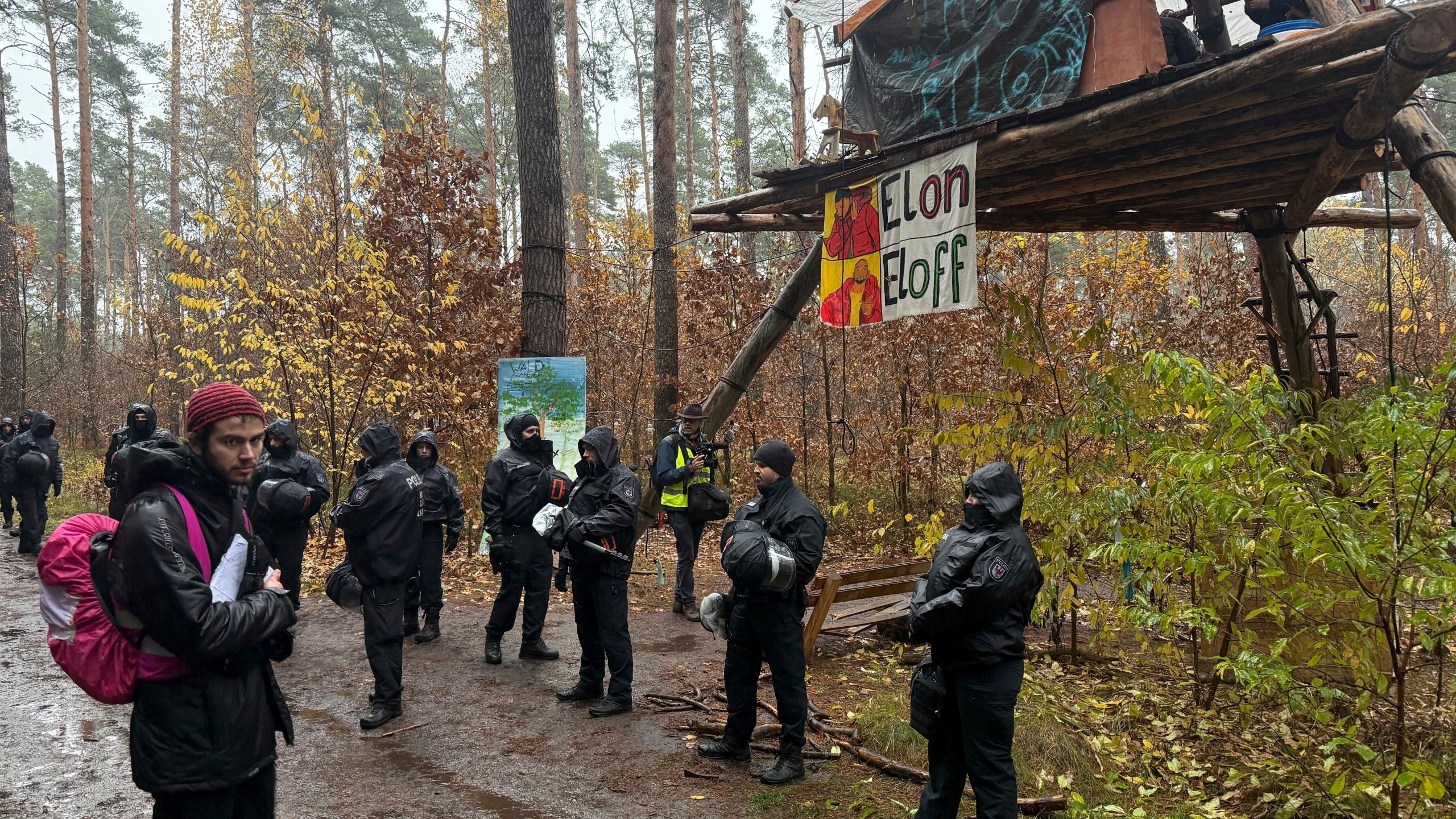 Police officers break up a protest camp housing environmental activists at the Tesla protest camp in the forest near the car factory in Grünheide, Germany, Tuesday Nov. 19, 2024. (Lutz Deckwerth/dpa via AP)