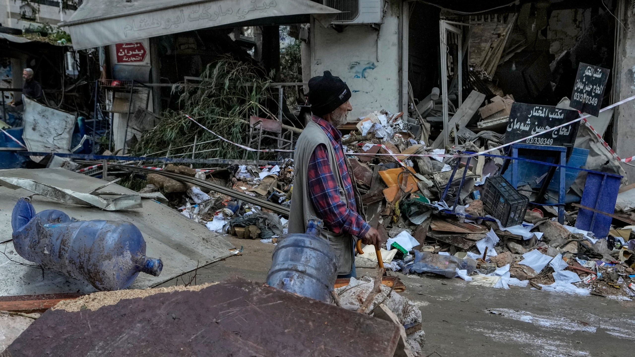 A man passes in front of a destroyed building hit on Monday evening by an Israeli airstrike in central Beirut, Lebanon, Tuesday, Nov. 19, 2024. (AP Photo/Bilal Hussein)