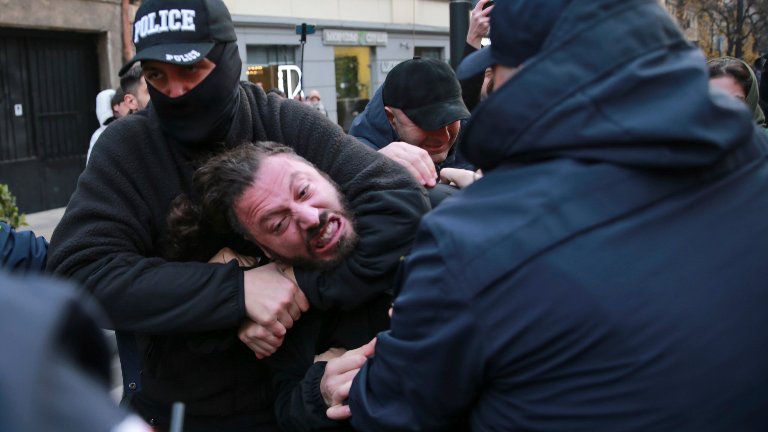 CORRECTS DAY AND DATE: Police try to detain a protester in a street during a rally against the results of the parliamentary elections amid allegations that the vote was rigged in Tbilisi, Georgia, Tuesday, Nov. 19, 2024. (AP Photo/Zurab Tsertsvadze)