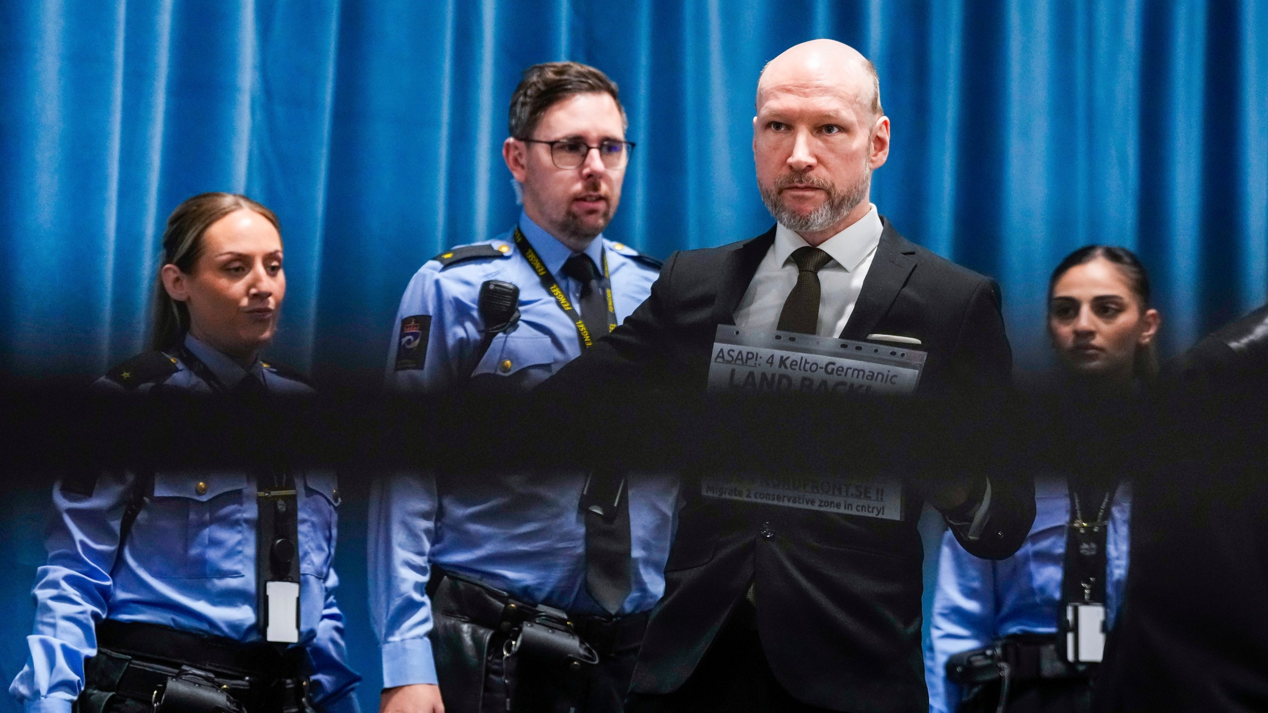 Anders Behring Breivik arrives at the courtroom for day one of the Ringerike, Asker and Bærum district court's processing of Fjotolf Hansen's petition for parole, in Tyristrand, Norway, Tuesday, Nov. 19, 2024. (Beate Oma Dahle/NTB Scanpix via AP)