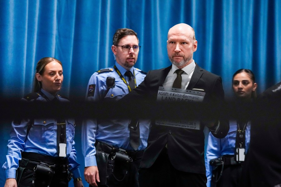 Anders Behring Breivik arrives at the courtroom for day one of the Ringerike, Asker and Bærum district court's processing of Fjotolf Hansen's petition for parole, in Tyristrand, Norway, Tuesday, Nov. 19, 2024. (Beate Oma Dahle/NTB Scanpix via AP)