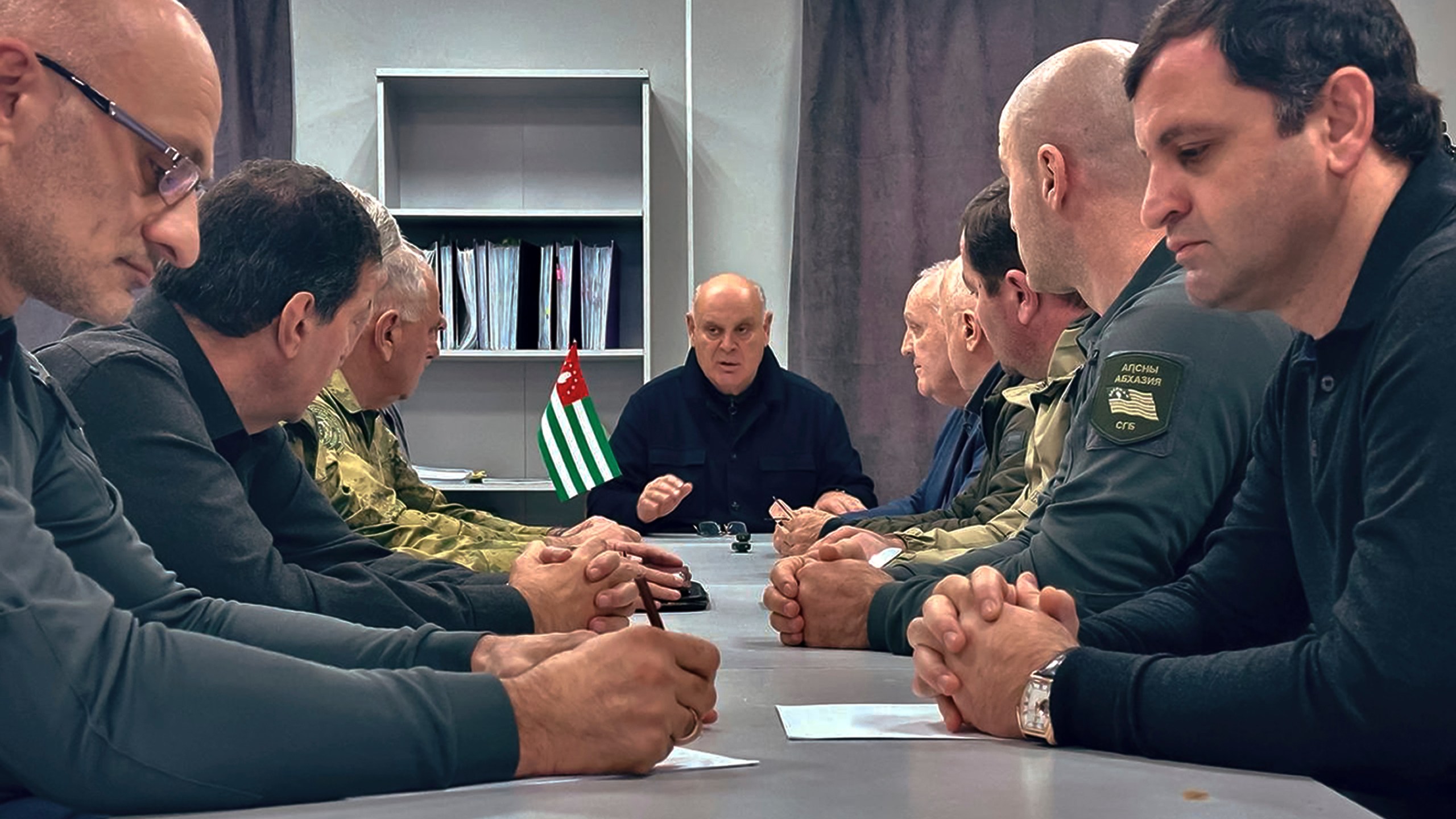 In this photo taken from video released by Information Center of the President of the Republic of Abkhazia on Monday, Nov. 18, 2024, Abkhazian President Aslan Bzhania, center, chairs a Security Council meeting in the village of Tamishi, in Georgia’s breakaway province of Abkhazia. (Information Center of the President of the Republic of Abkhazia via AP)