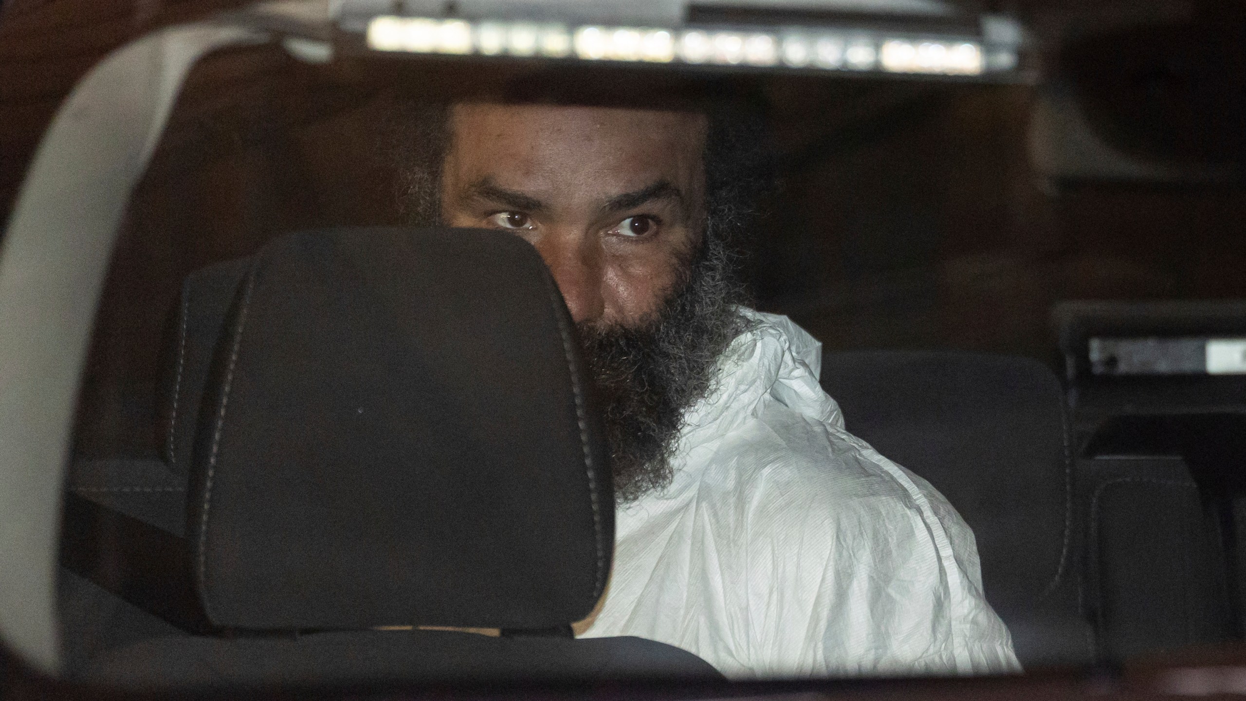 Ramon Rivera, a suspect arrested after multiple people were stabbed early Monday, is escorted out by NYPD officers at the NYPD 10th Precinct in New York, Monday, Nov. 18, 2024. (AP Photo/Yuki Iwamura)