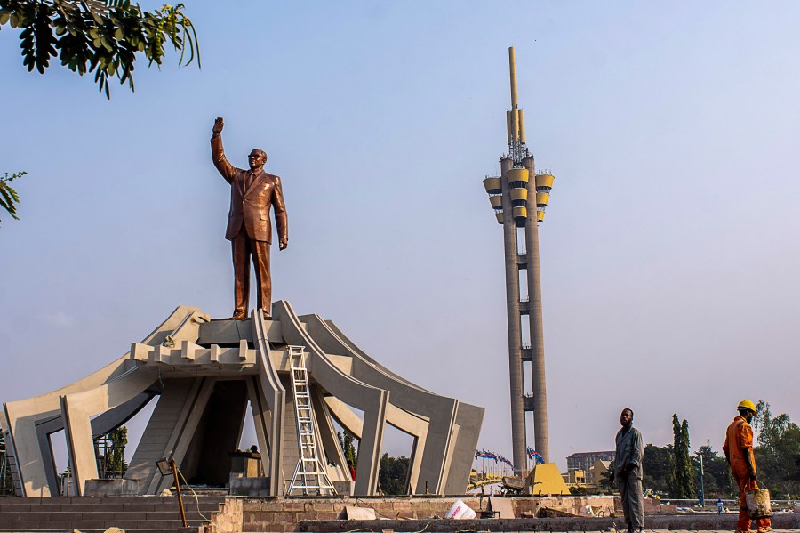 FILE - Workers stand by a memorial for Democratic Republic of the Congo independence hero Patrice Lumumba, in Kinshasa, Congo, June 20, 2022. (AP Photo/Samy Ntumba Shambuyi, File)