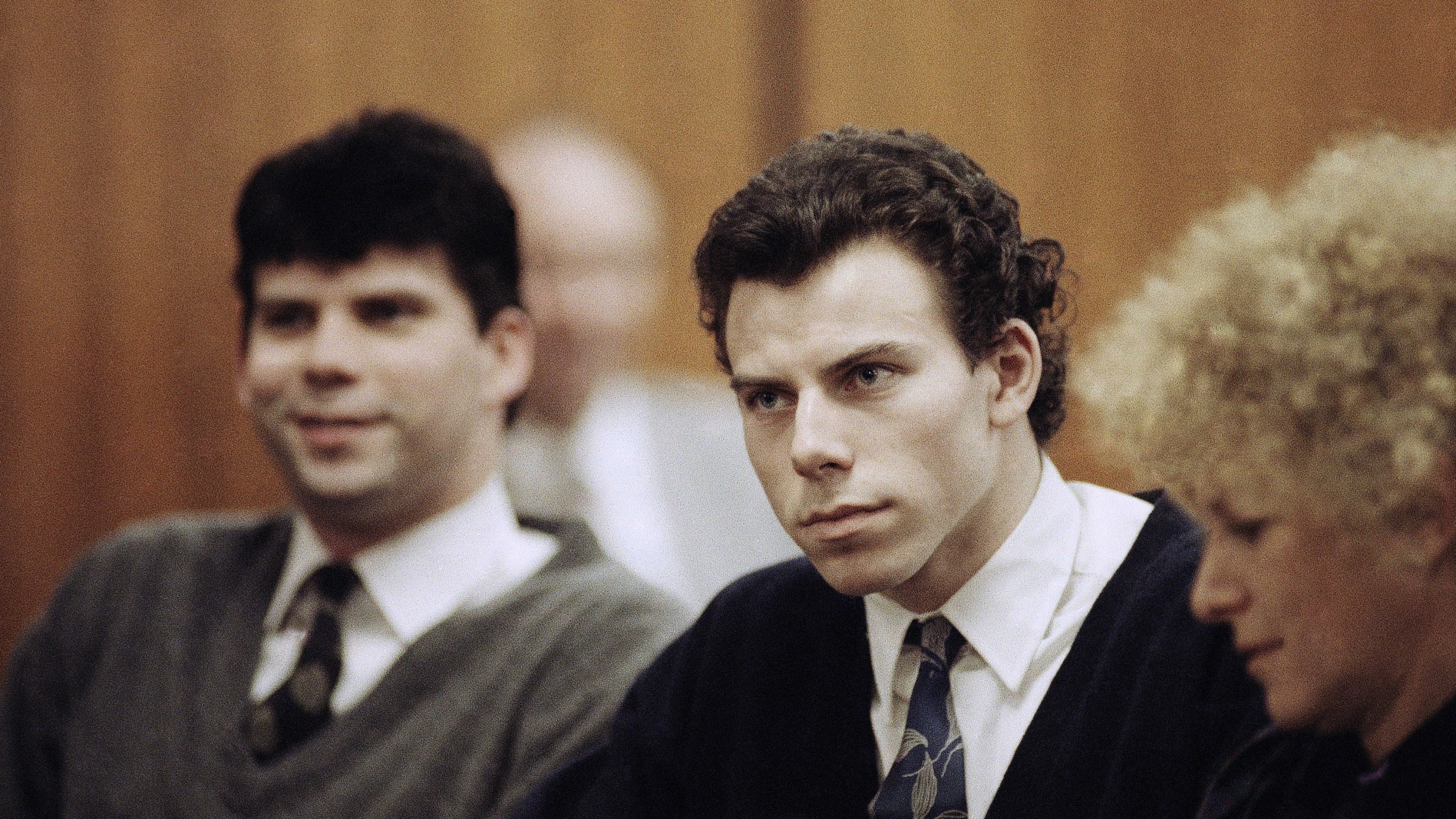 FILE - Lyle, left, and Erik Menendez sit with defense attorney Leslie Abramson, right, in the Municipal Court in the Beverly Hills area of Los Angeles, during a hearing, Nov. 26, 1990. (AP Photo/Nick Ut, File)