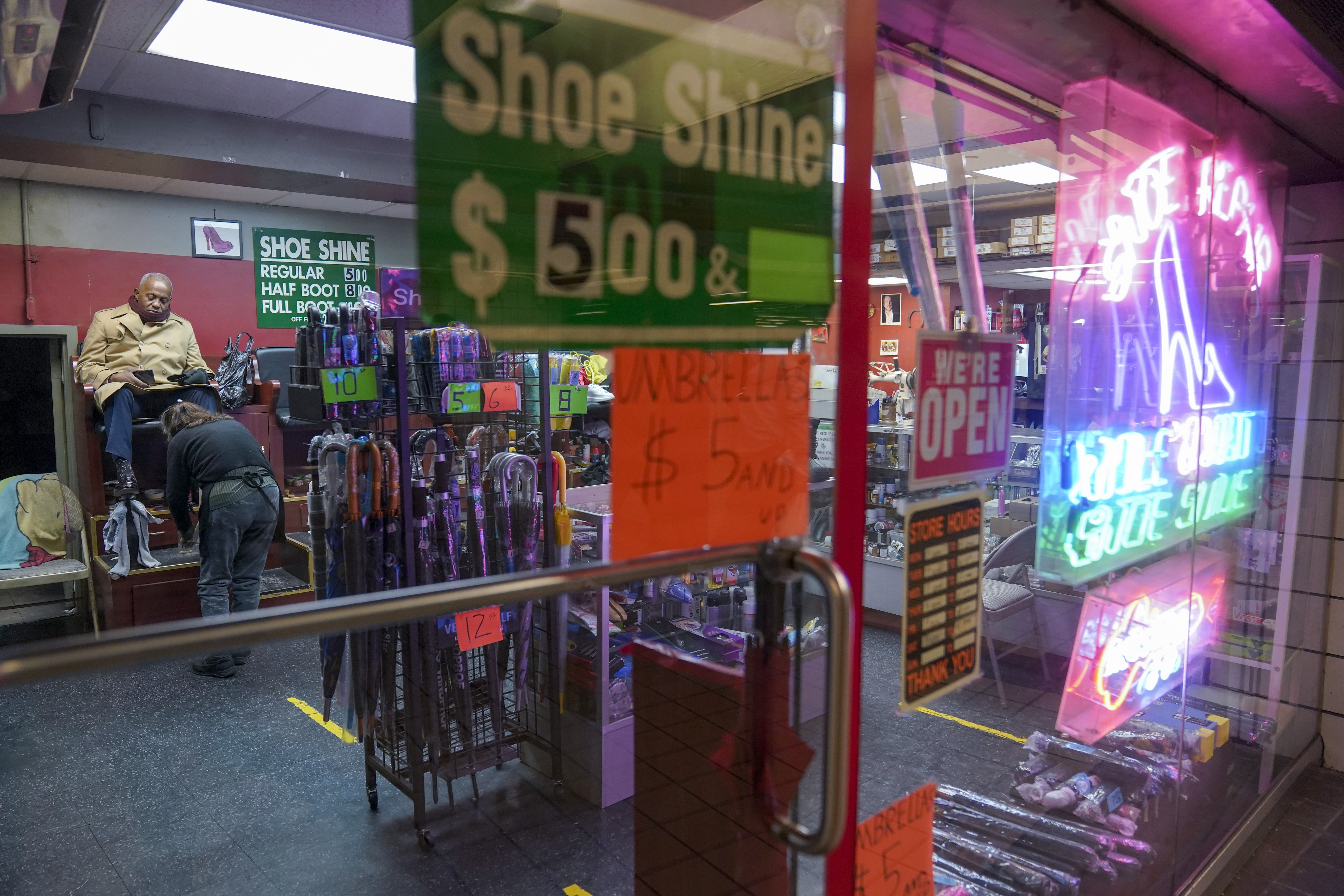 FILE - A customer sits for a shoe shine at a shoe repair shop on Feb. 3, 2023, in New York. (AP Photo/Mary Altaffer, File)