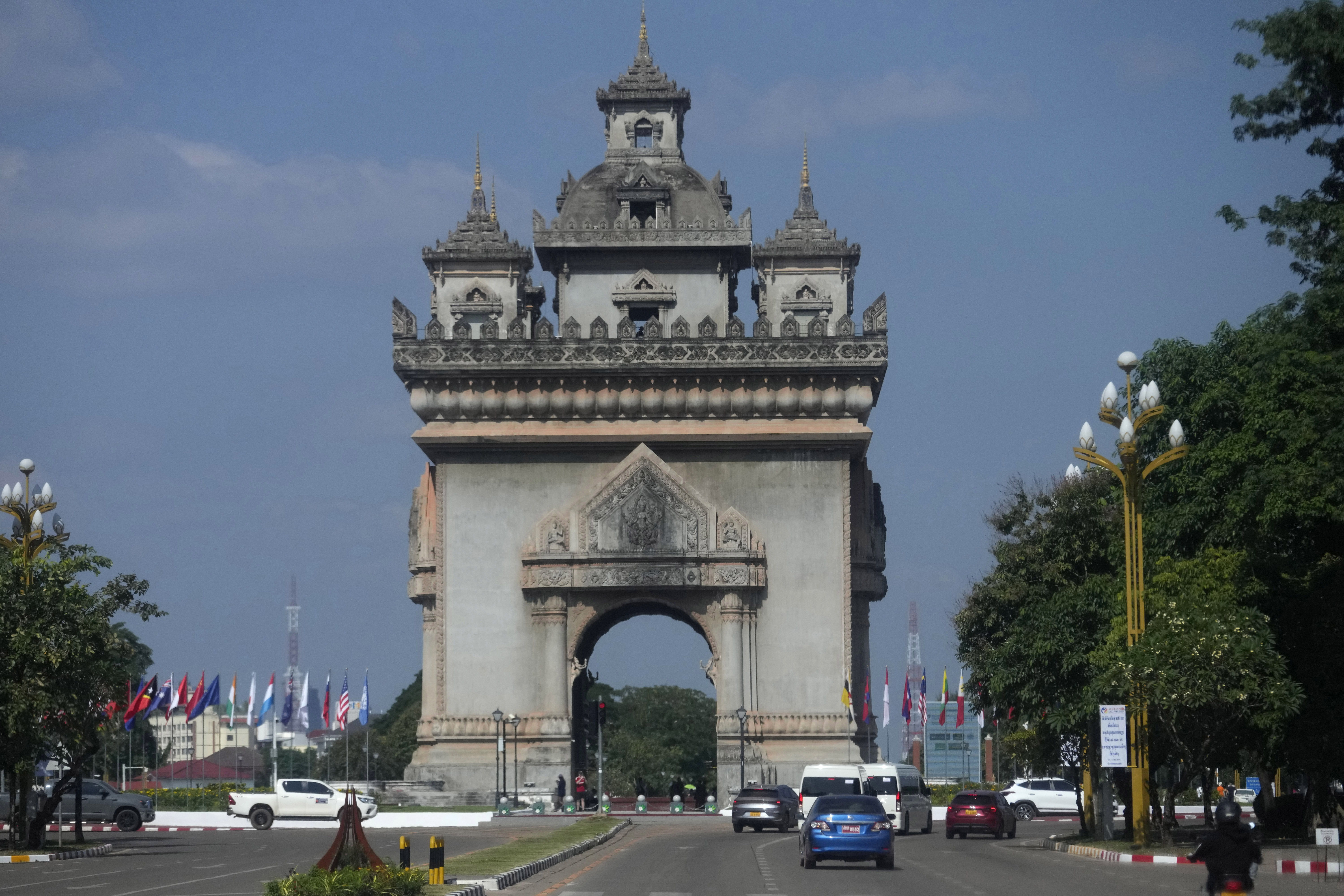 FILE- Cars drive in front of the Patuxay victory monument in Vientiane, Laos, Monday, Oct. 7, 2024. (AP Photo/Sakchai Lalit, File)