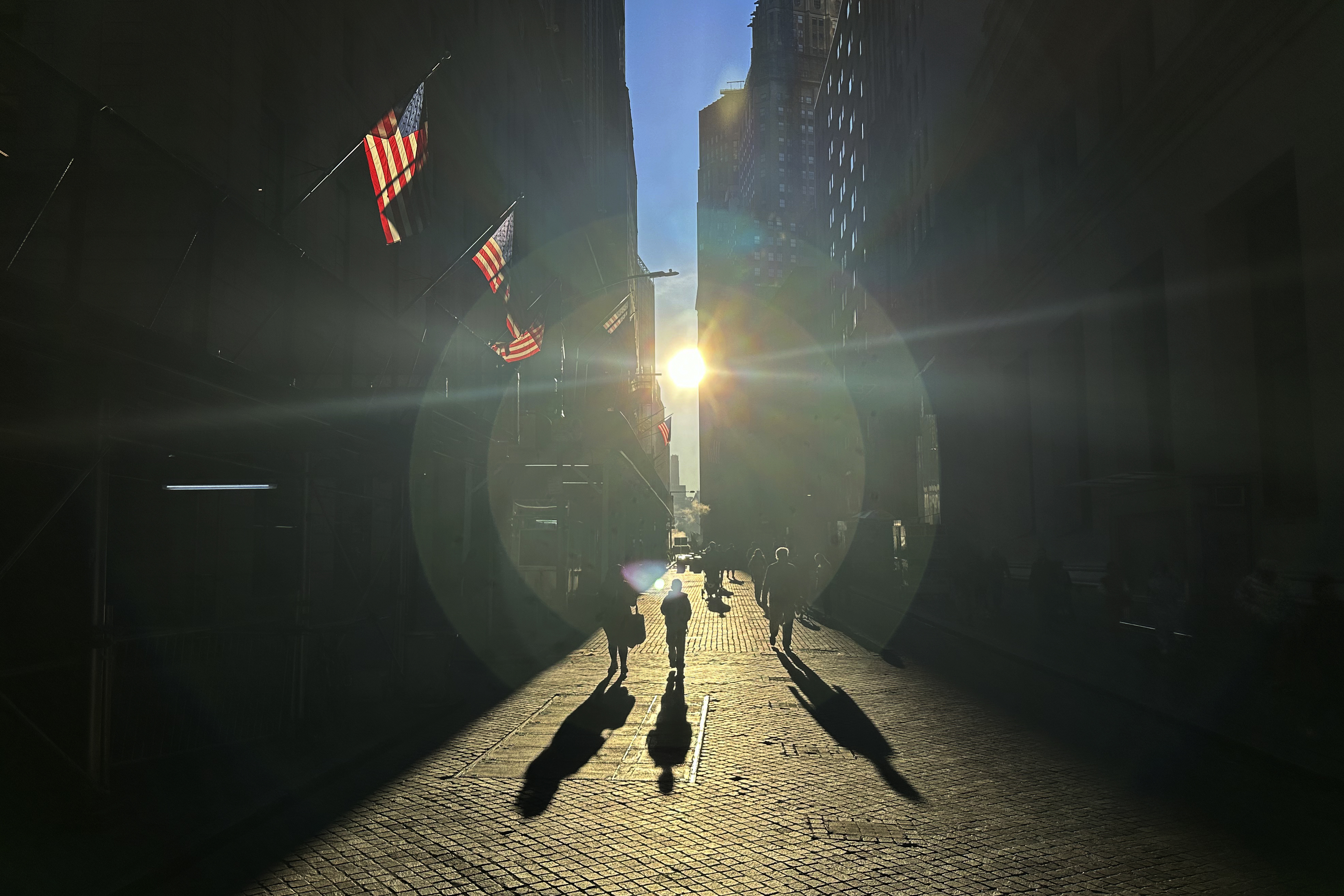 FILE - The morning sun shines on Wall Street in New York's Financial District on Tuesday, Nov. 19, 2024. (AP Photo/Peter Morgan)